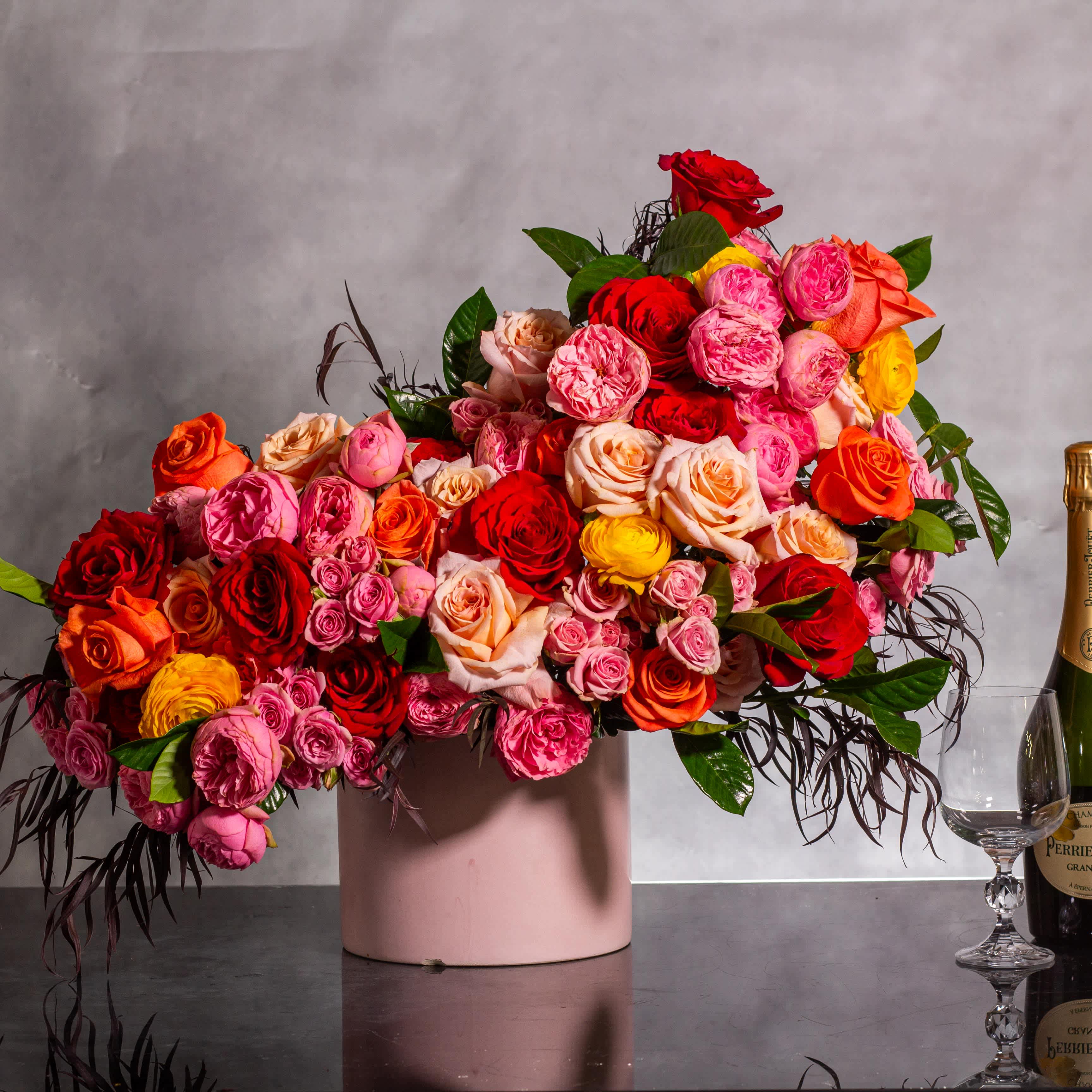 Let's Stay Together - Blooms of Joy and Unity - The &quot;Let's Stay Together&quot; floral arrangement bursts with colorful roses, garden roses, and fun, cheerful hues, creating a vibrant and happy display. Approximately 21 inches wide and 16 inches tall, this arrangement is presented in a seven-inch round ceramic vase with a textured finish, perfect for any joyous occasion or to lift someone's spirits. As your Beverly Hills local florist, we provide same-day delivery to bring a touch of happiness right to your doorstep. 