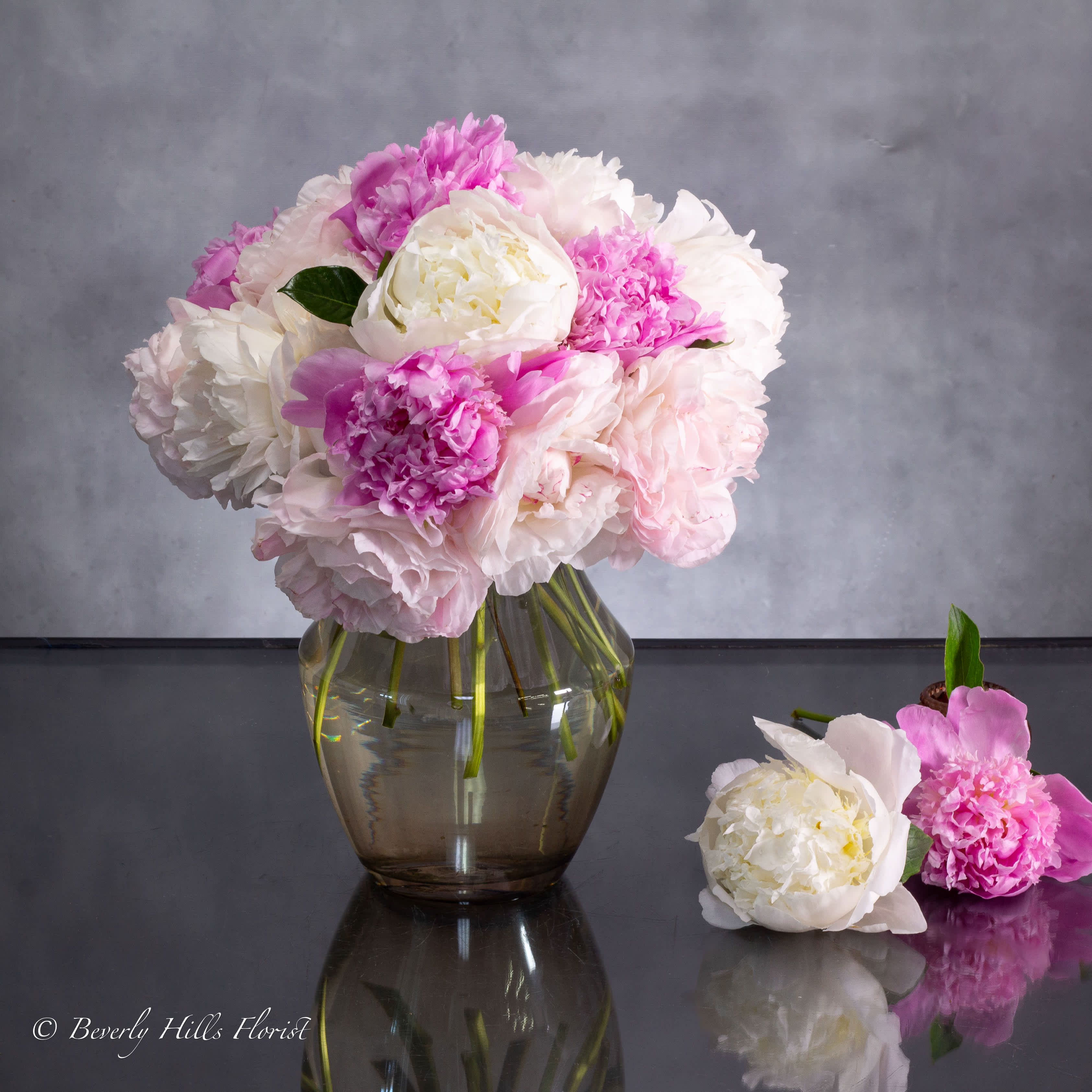ETHEREAL ELEGANCE - Available for Same-Day Delivery!  Nestled within a sleek vase, the Ethereal Elegance arrangement embodies the delicate charm of springtime. Soft hues of pink and pristine white interlace in a dance of natural beauty, creating a captivating centerpiece that exudes timeless elegance.