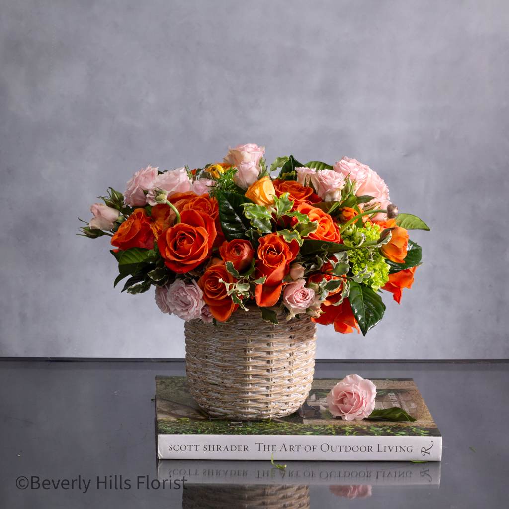 Sunset Serenade - A Tale of Orange and Pink - Beverly Hills Same Day Delivery - The combination of pink spray roses in a ceramic basket-like container sounds absolutely enchanting. The contrast between the delicate pink roses and the decorative ceramic pot is sure to create a stunning visual impact. It's the kind of arrangement that would brighten any space and bring a touch of elegance to any occasion. If you're envisioning this as a gift or a centerpiece, it's bound to be a delightful surprise for anyone lucky enough to receive it!  Approx. 11&quot; round 