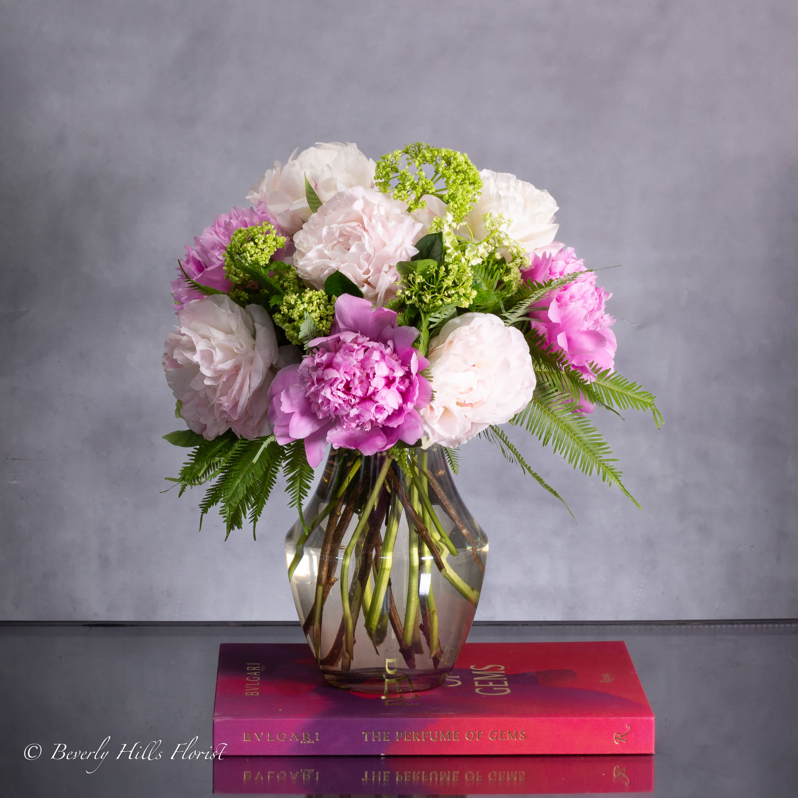 SPRING BLOSSOM HAVEN - Available for Same-Day Delivery!  Nestled within a sleek vase, the Ethereal Elegance arrangement embodies the delicate charm of springtime. Soft hues of pink and pristine white interlace in a dance of natural beauty, creating a captivating centerpiece that exudes timeless elegance.  8&quot; tall vase overall 16&quot; tall