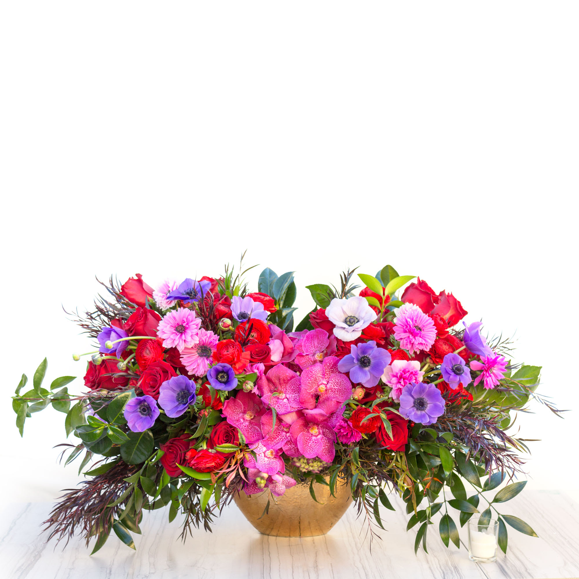 Rubies and Amethyst Rubies and Amethyst - Striking and vibrant blooms in pinks, reds, and purples radiate from this abundant cluster of Roses, Orchids and seasonal flowers accented with cascades of airy greens. Lovely for fall and any occasion.