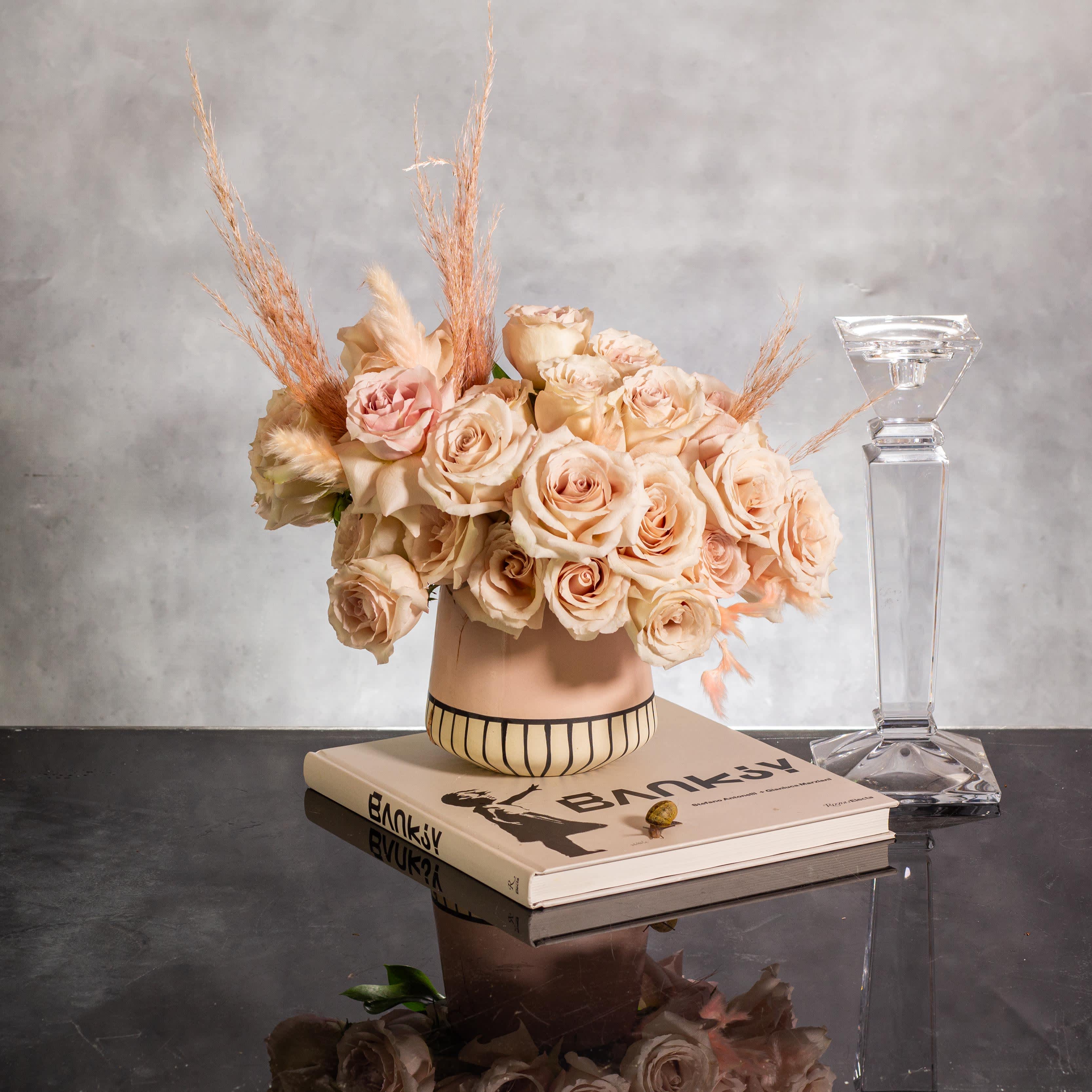 Sandy Elegance - Modern Rose Display - The sand color roses are elegantly displayed in a modern 6-inch tall ceramic vase, complementing the roses beautifully. With an approximate width of 10 inches and height of 11 inches, this arrangement exudes a modern and classy vibe, perfect for adding a touch of sophistication to any space. As your local Beverly's florist, we offer same-day delivery to ensure this elegant display brightens up your day promptly.