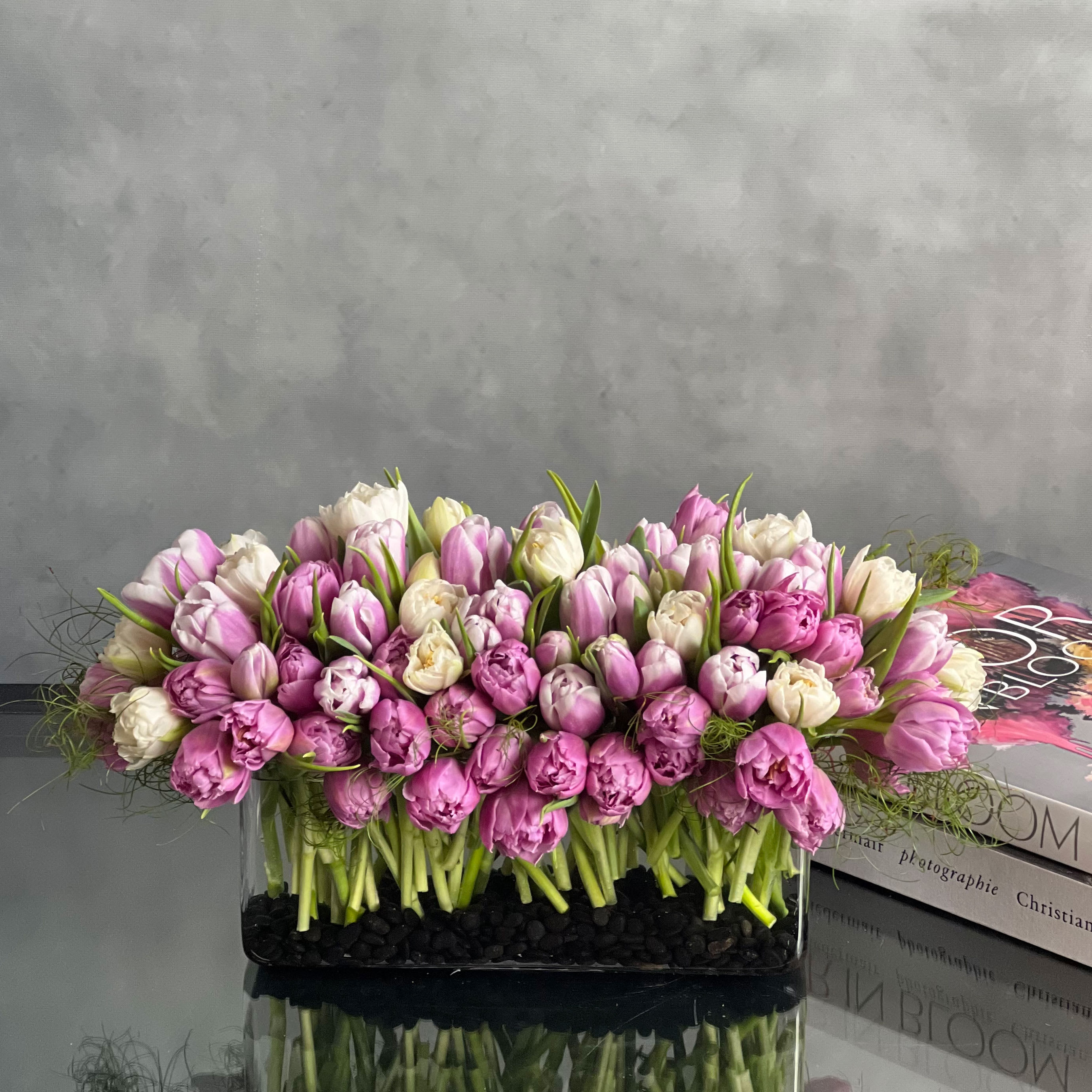 Tulips please! - This modern low centerpiece of tulips will surely impressed anyone. Rows of white, purple and lavender tulips.  Overrall: 18x10