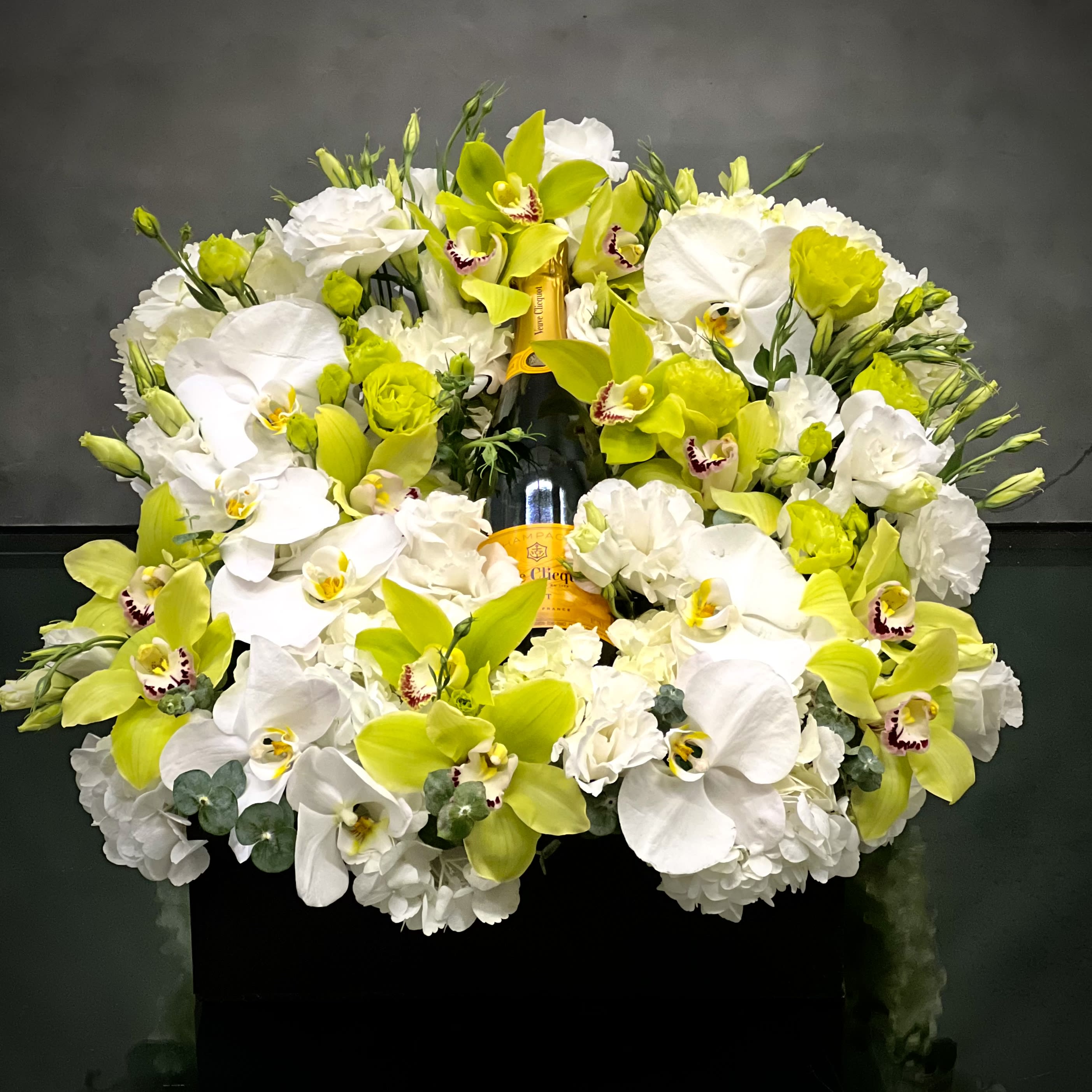 Champagne gift box  - The perfect gift box for Father’s Day and any other celebration is filled with premium imported such orchids and other locally sourced blooms  This gift box is ready for same day Delivery.    Approx.: 26” square 