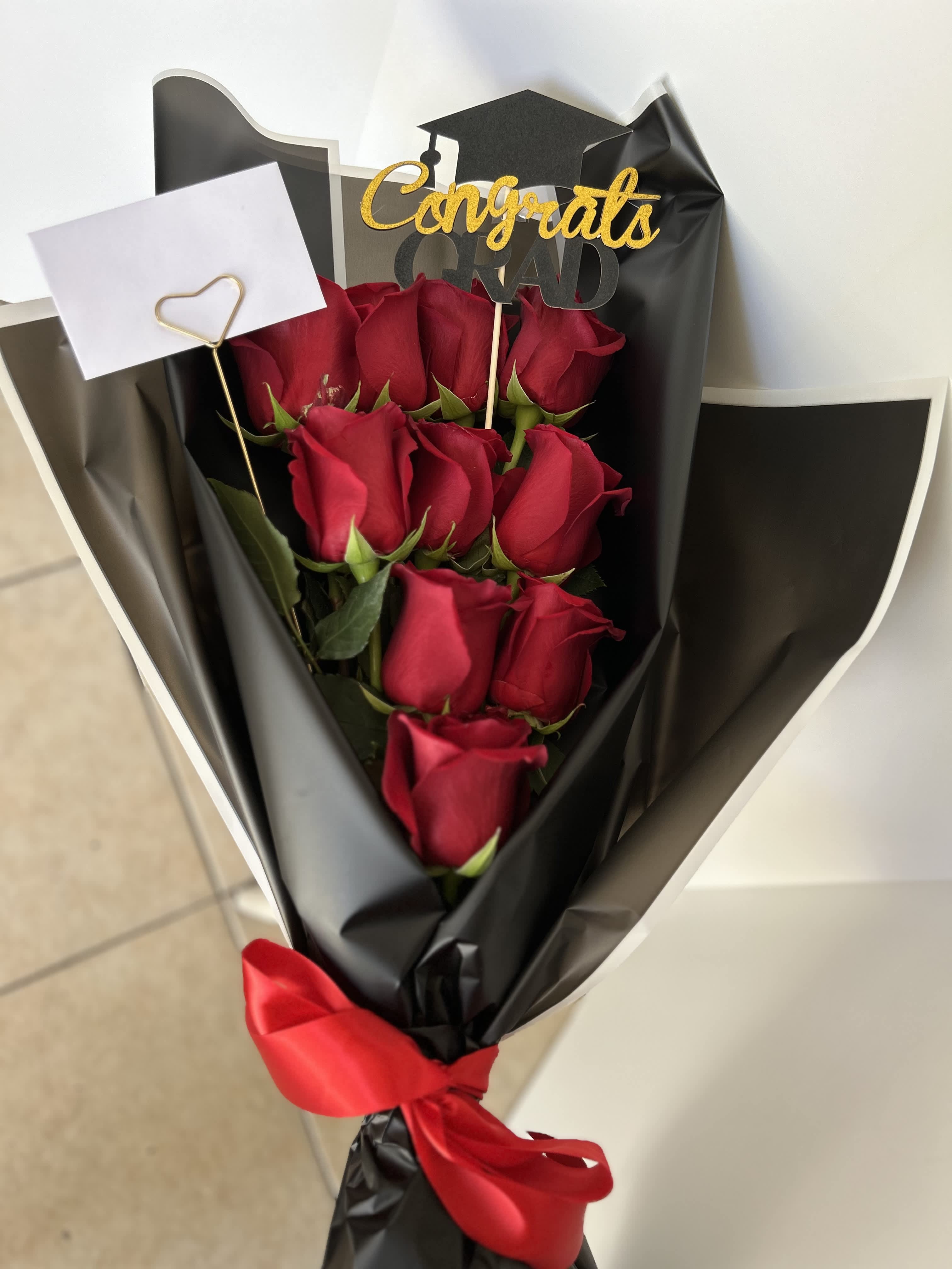 Grad bouquet  - Red roses wrapped with black paper and graduation topper