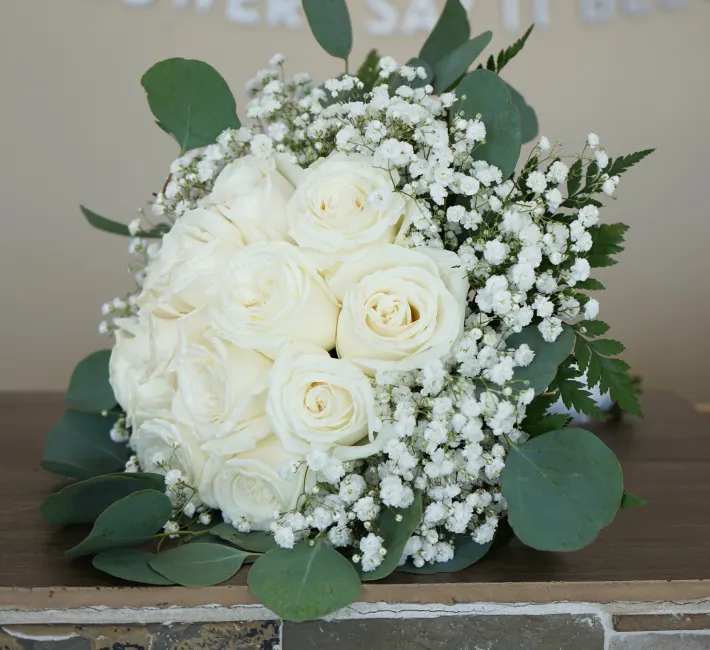 Timeless White Elegance Timeless White Elegance - This exquisite handheld wedding bouquet features a classic and elegant combination of white roses and baby’s breath. The white roses symbolize purity, innocence, and everlasting love, while the baby’s breath adds a touch of sweetness and delicate charm. This timeless bouquet is perfect for the bride who desires a simple and sophisticated look on her wedding day.