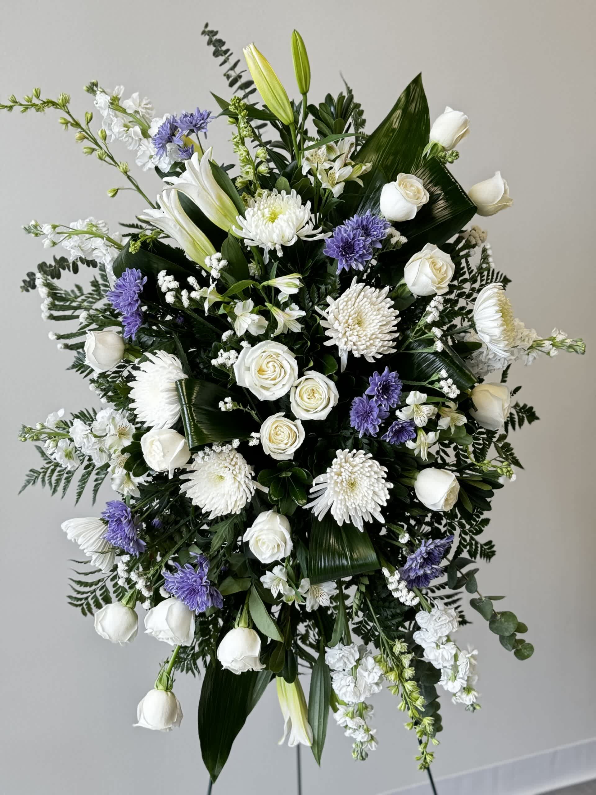 Sympathy Spray - This beautiful spray is arranged with Lillys, cushion mums, lisianthus, white stock, cremone mums and greens. Colors can be customized.