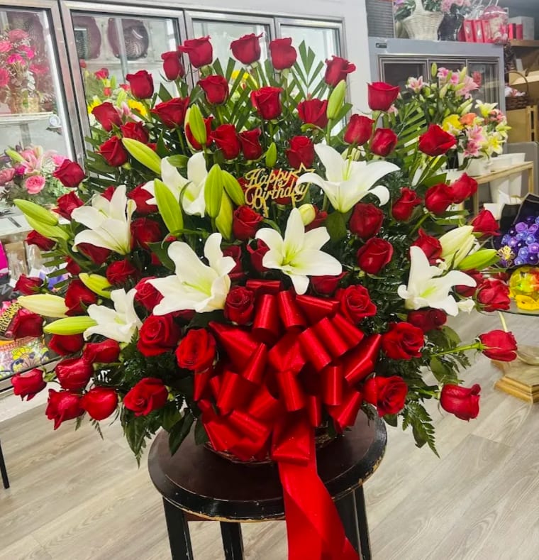 50 Red Rose Arrangement 50 Red Rose Arrangement - 50 Red rose arrangement in a large basket with white lilies and large red bow.
