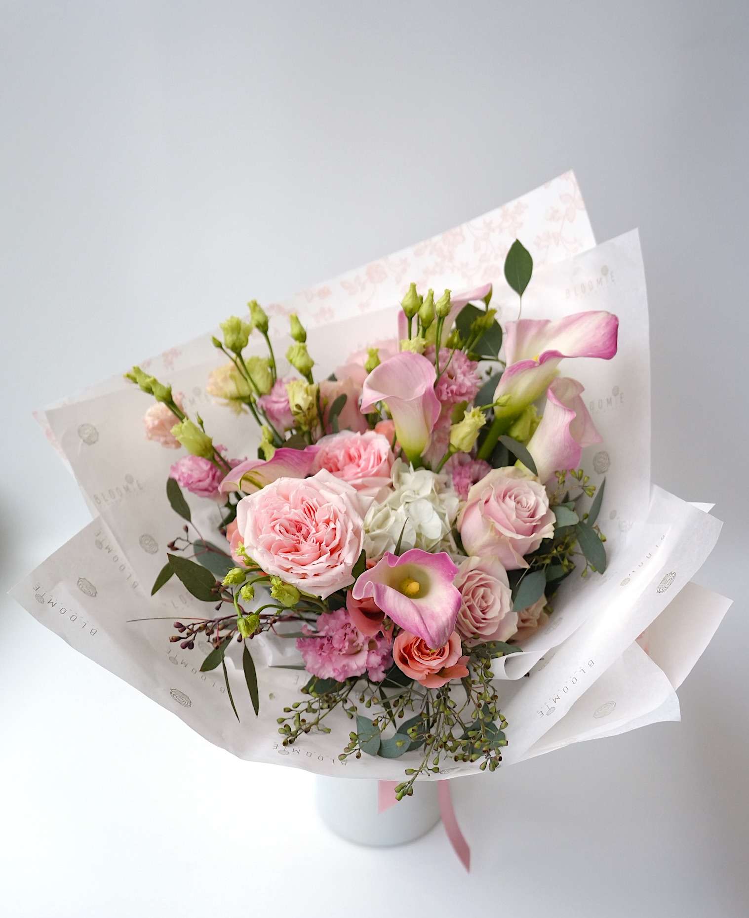 Blooming Elegance - A refined and sophisticated bouquet, in soft and gentle pink hues of garden roses, calla lilies, and hydrangea. Note: The vase is not included.