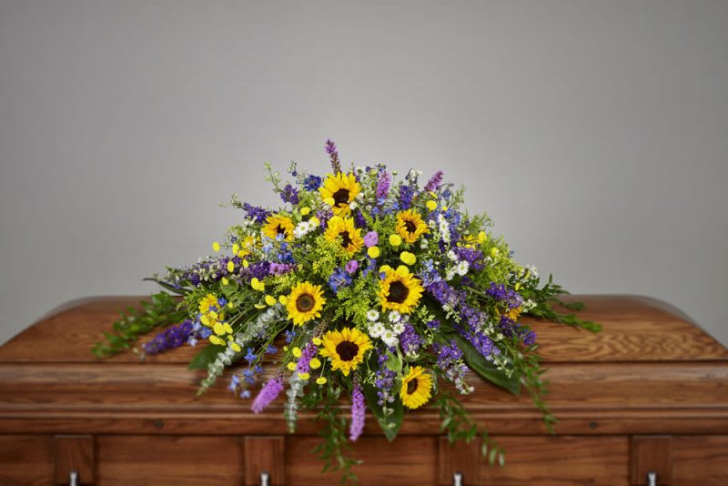 Eternally Remembered - Adorn the final resting place of a cherished friend or loved one with this exquisite casket cover. Brimming with vibrant, fresh flowers, this piece is a truly touching gesture of your deepest sympathy, support and fond remembrance.