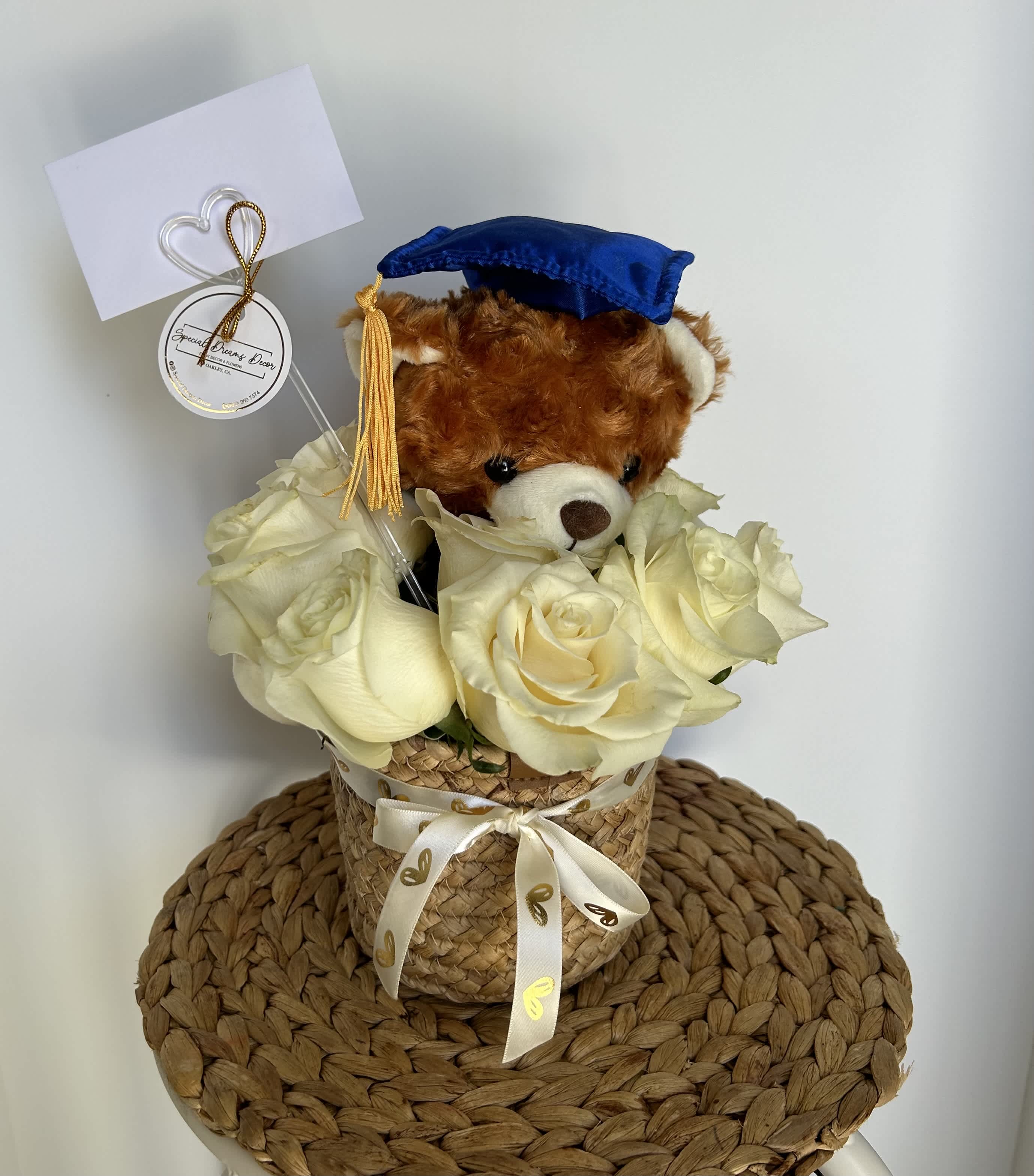 Grad Teddy Bear flower arrangement  - Grad teddy bear in a wicker vase with roses