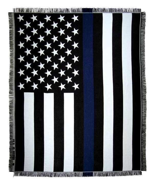 Thin Blue Line Woven Throw - This full size woven throw displays traditional imagery of the Thin Blue Line. An American flag in black and white size a single deep blue stripe on the flag. Honor those who honored us with their service.