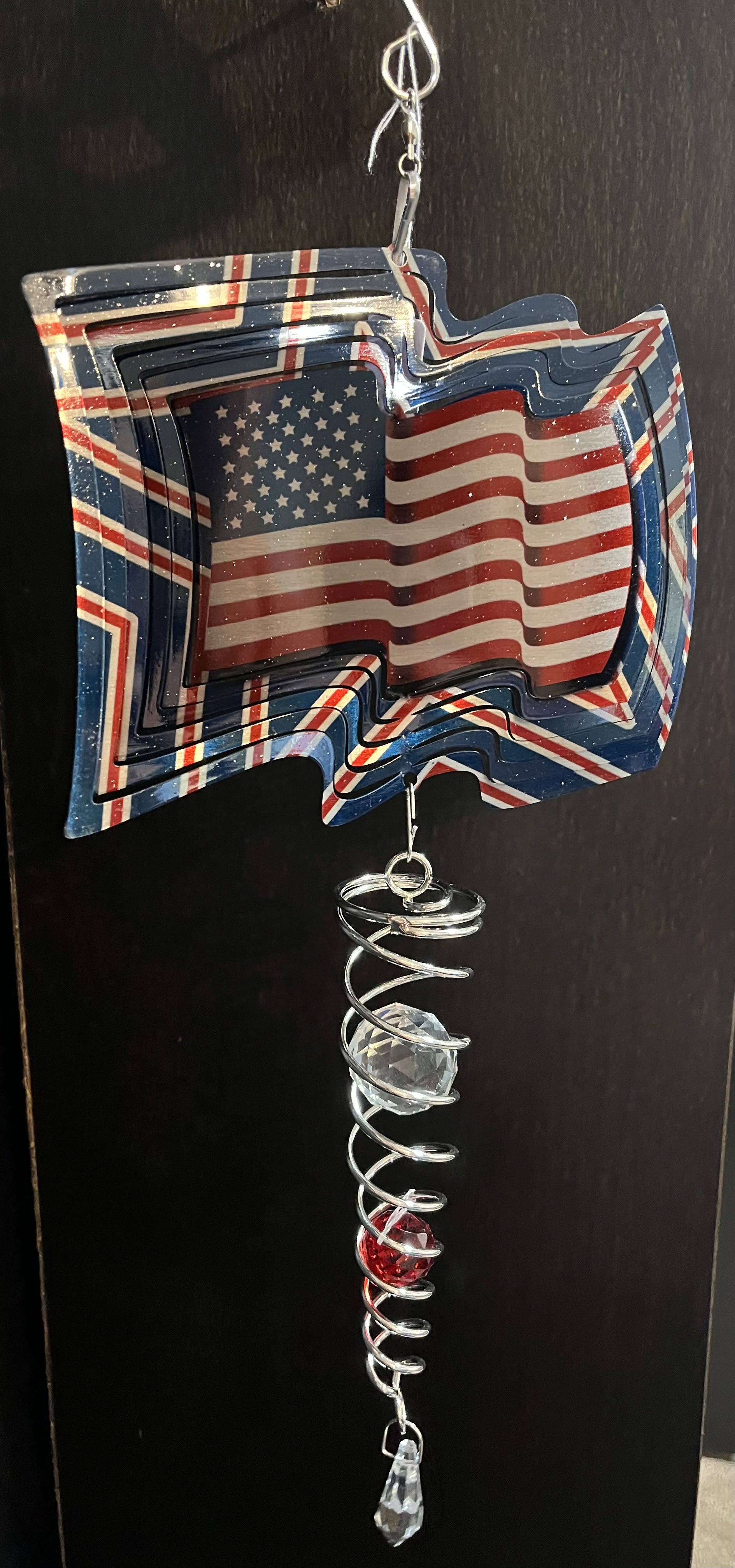 American Flag Mini - wind spinner - 16 inch tall Unique and wonderful gift to memorialize a fallen soldier or veteran.  Also, a great way to celebrate any American holiday.  Powder coated stainless steel wind spinner with glass cut crystal.  