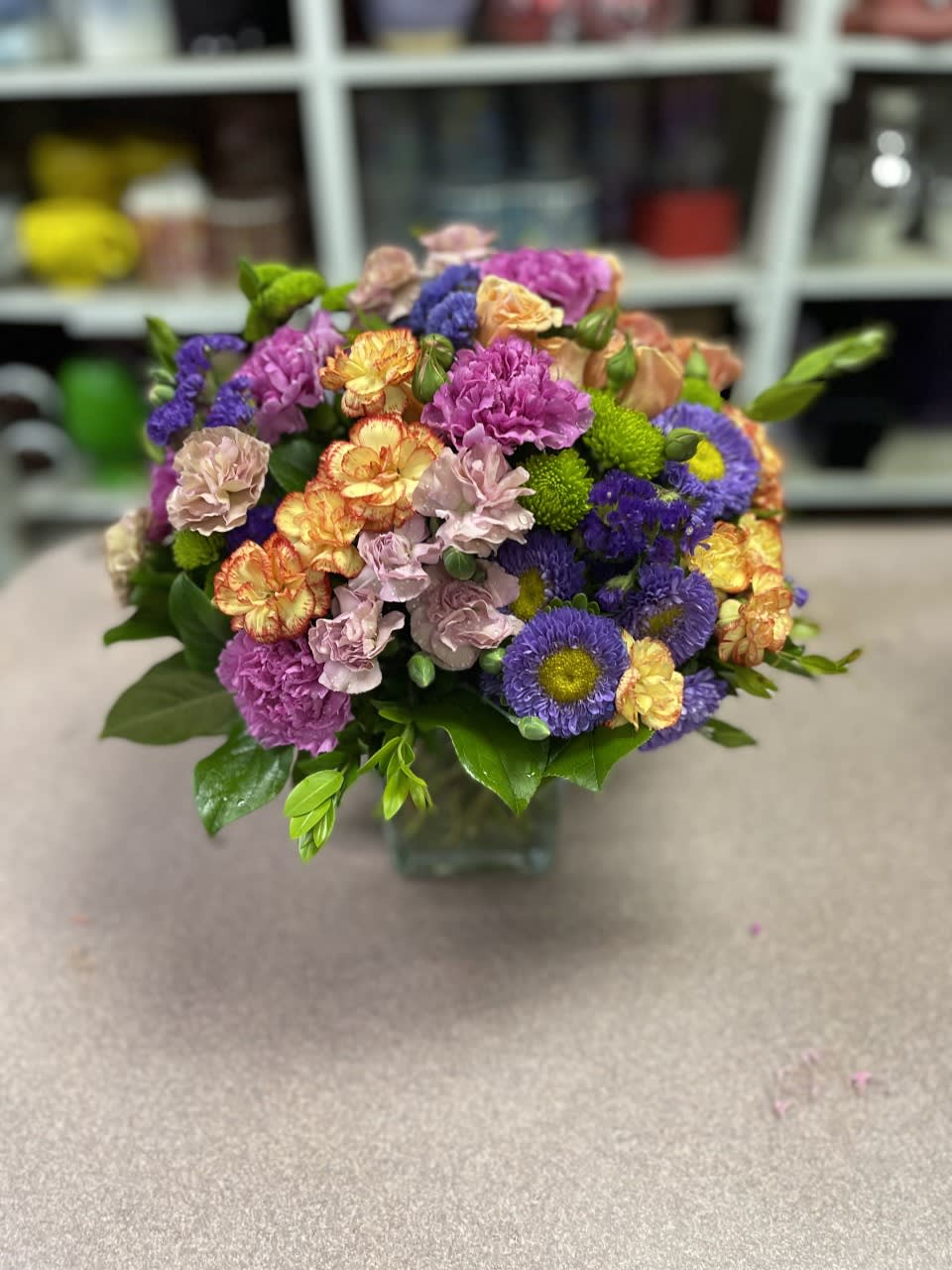 Say it with Flowers - An abundance of carnations, matsumoto, buttons, and topped with spray roses. This can be made in any color variety and is a very long- lasting assortment of flowers. 