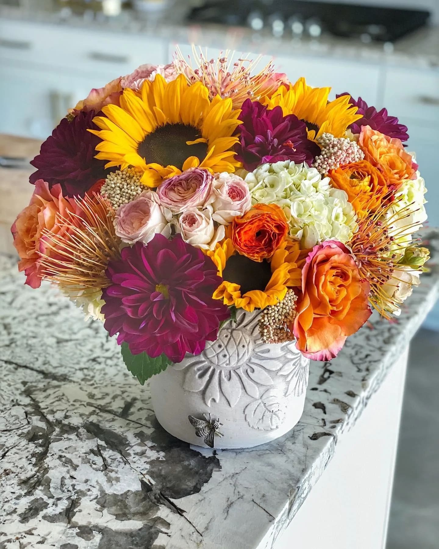 Sunflower Harvest - Loving this lush and bold bouquet of sunflowers with pops of vibrant colors. This is sure to dress up any occasion!  *vase is subject to change due to availability.