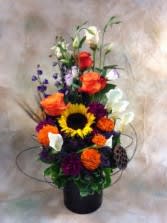 Sunflowers and Friends Sunflowers and Friends - An entryway arrangement for your home that features sunflowers, miniature callas and lisianthus, with local organic marigolds that smolder in the background.