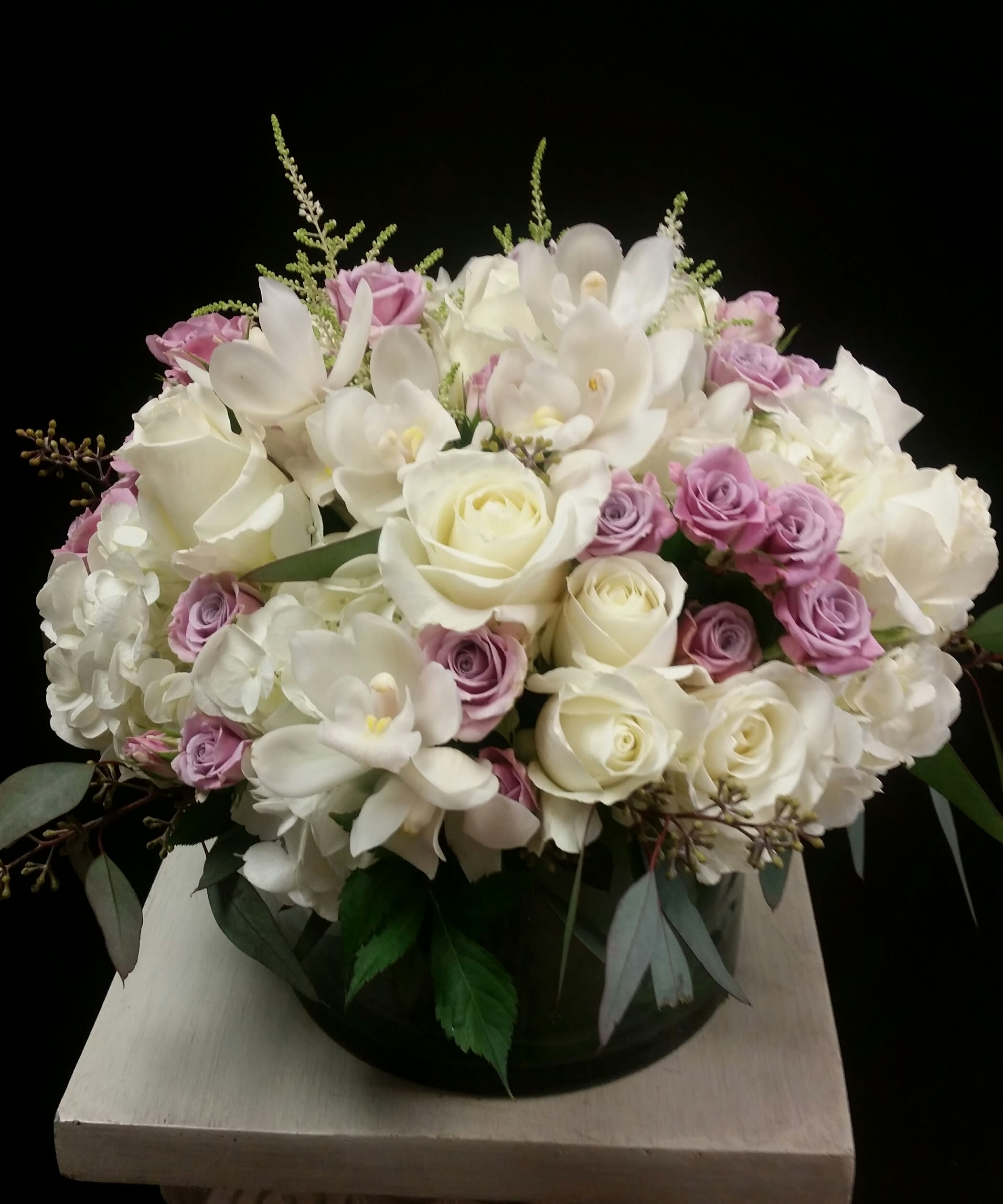 Rosificiation Rosificiation - White Eskimo roses, white phalaenopsis orchids, hydrangea, peonies (in season), and lavender spray roses make this splendid arrangement memorable.
