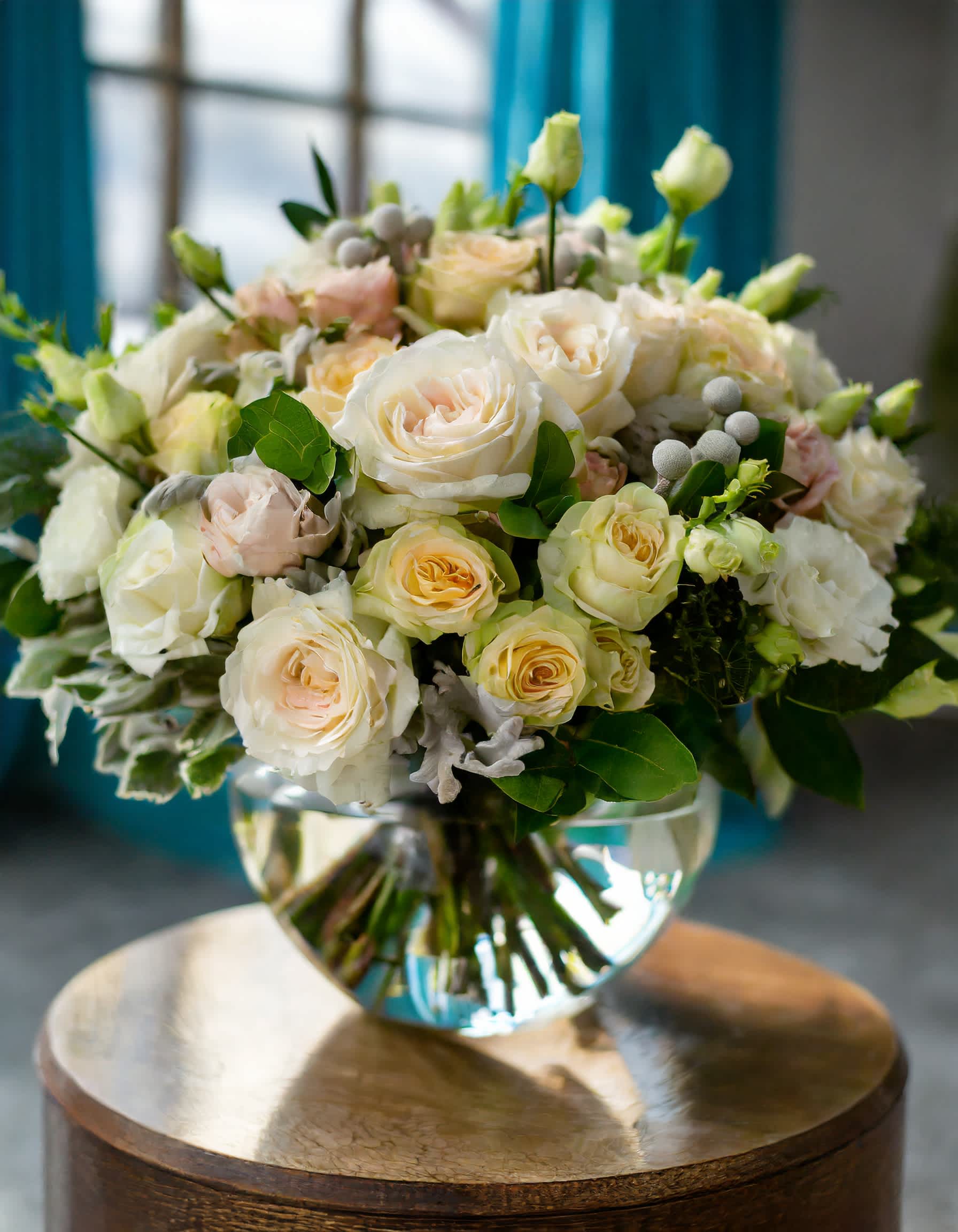 Ivory Charm - A charming and beautiful bouquet featuring ivory roses, cream spray roses, and an assortment of mixed flowers, elegantly presented in a clear vase.  Disclaimer: ALL IMAGES PROVIDED AT DELUXE PRICE Photos and visual presentation of the products represent an overall style, look and feel, which we may not be able to identically replicate in some instances  Recommended for: Love and Romance, I Love You Flowers, Anniversary, Proposal,  Romantic Gift, Birthday, Get Well Soon, Celebrations, Best Wishes, Thank You, Congratulations, Just Because, New Baby, Everyday, Sympathy 