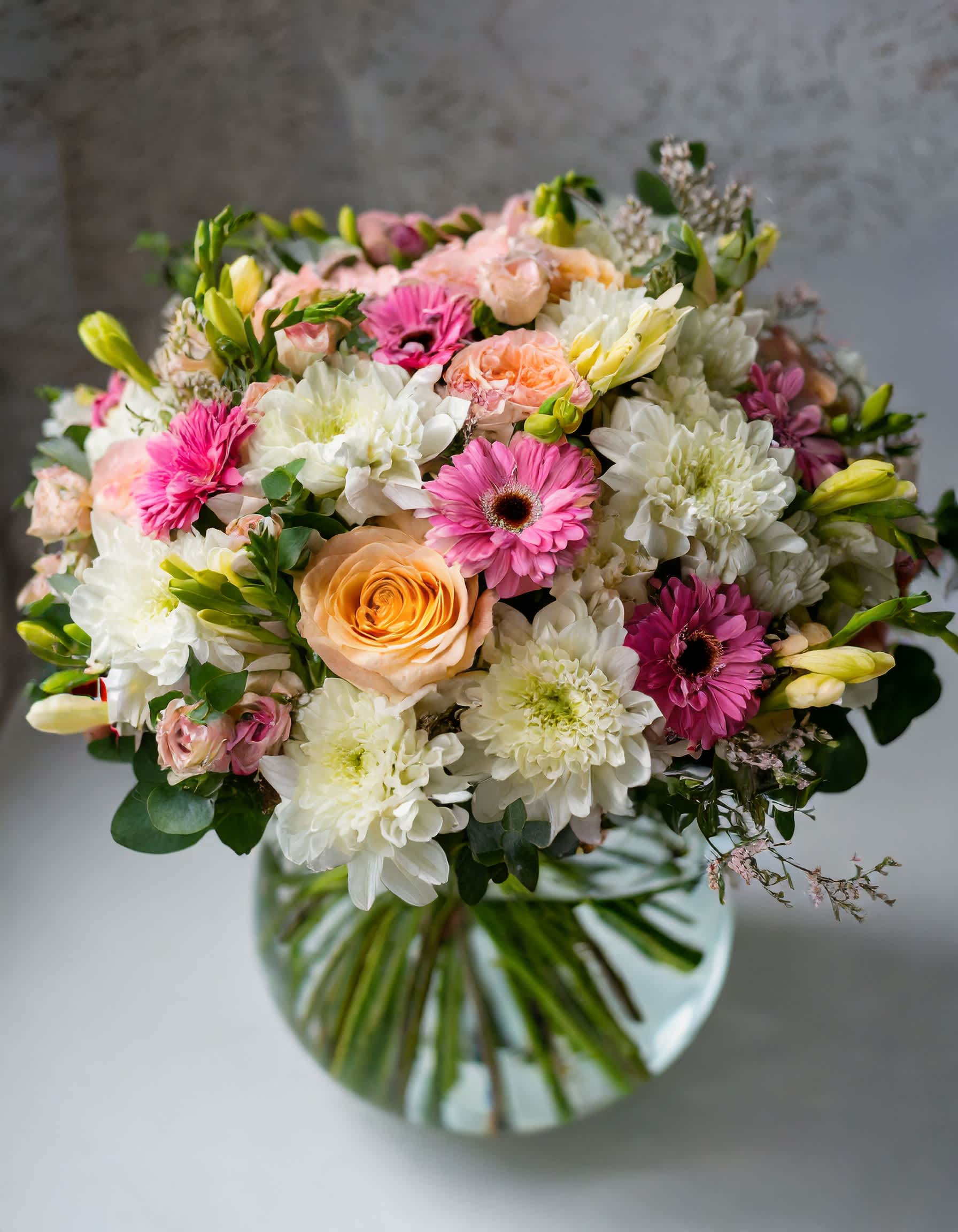 Mysterious Melody Bunch - A charming and beautiful bouquet in a clear vase, featuring a delightful mix of pink and white flowers. This lovely arrangement includes roses, dahlias, and an assortment of other blossoms, creating a delightful blend of colors and blooms.  Disclaimer: ALL IMAGES PROVIDED AT DELUXE PRICE Photos and visual presentation of the products represent an overall style, look and feel, which we may not be able to identically replicate in some instances  Recommended for: Love and Romance, I Love You Flowers, Anniversary, Proposal,  Romantic Gift, Birthday, Get Well Soon, Celebrations, Best Wishes, Thank You, Congratulations, Just Because, New Baby, Everyday, Sympathy