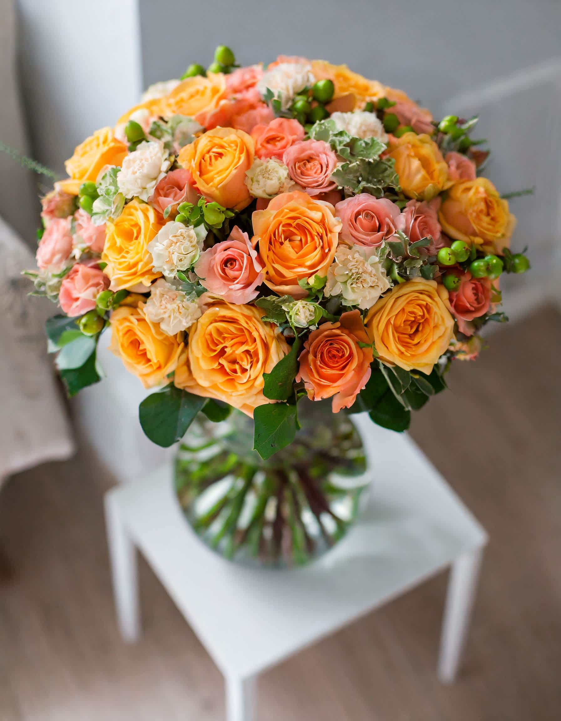 Sunset Sky - A breathtaking arrangement of flowers in a soft orange palette, creating a gentle and stunning composition. The beauty of this display is accentuated in a clear vase, capturing the essence of sunshine.  Disclaimer: ALL IMAGES PROVIDED AT DELUXE PRICE Photos and visual presentation of the products represent an overall style, look and feel, which we may not be able to identically replicate in some instances.  Recommended for: Love and Romance, I Love You Flowers, Anniversary, Proposal,  Romantic Gift, Birthday, Get Well Soon, Celebrations, Best Wishes, Thank You, Congratulations, Just Because, New Baby, Everyday, Sympathy 