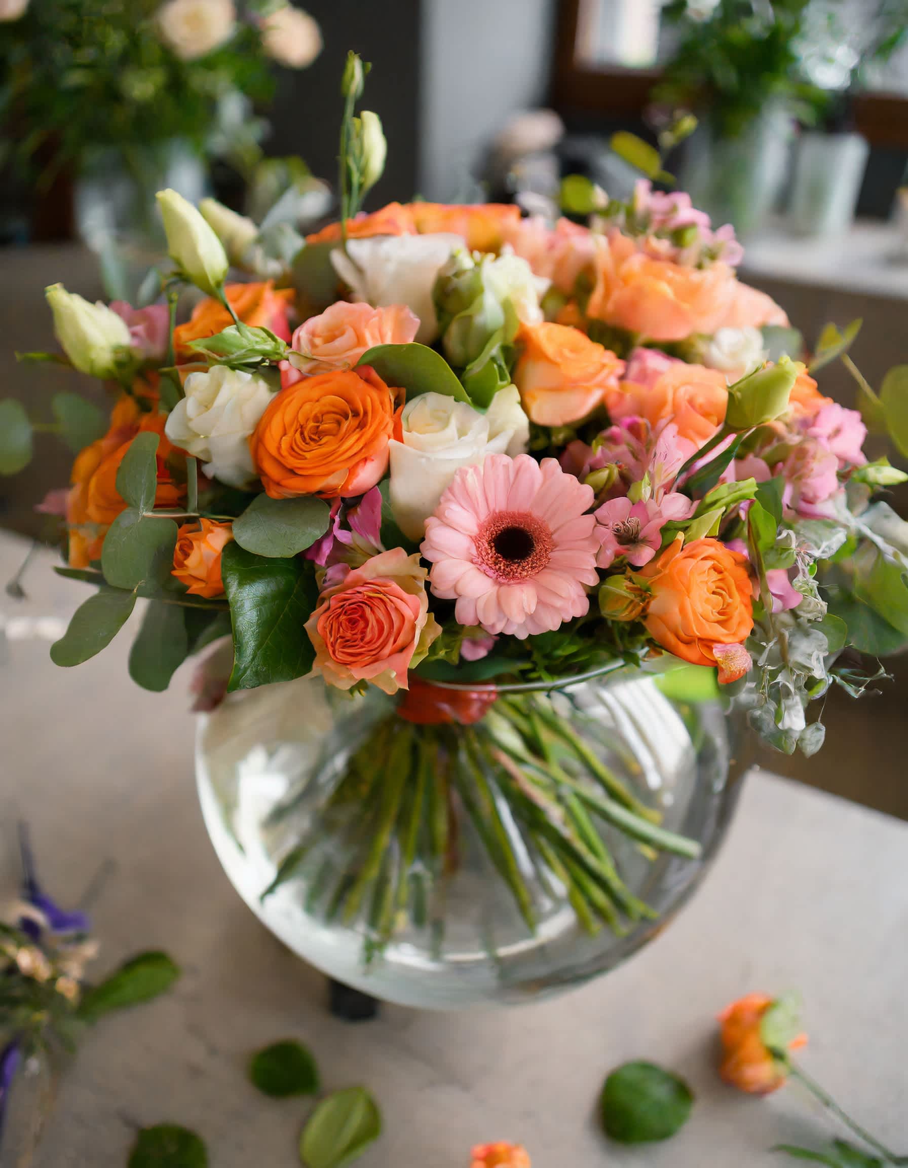 The Daydreamer - A composition of flowers in an orange and peach palette radiates warmth and sophistication, transforming into a classic display.  Disclaimer: ALL IMAGES PROVIDED AT DELUXE PRICE Photos and visual presentation of the products represent an overall style, look and feel, which we may not be able to identically replicate in some instances.  Recommended for: Love and Romance, I Love You Flowers, Anniversary, Proposal,  Romantic Gift, Birthday, Get Well Soon, Celebrations, Best Wishes, Thank You, Congratulations, Just Because, New Baby, Everyday