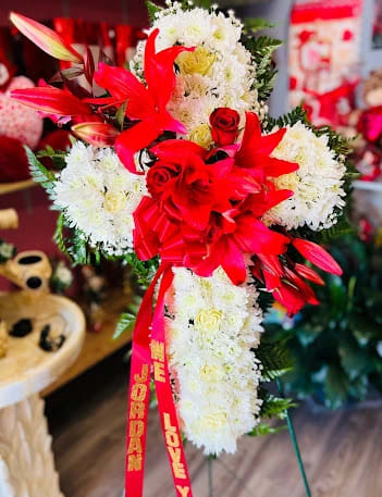 White & red sympathy cross White & red sympathy cross - Regular size white cross with Red filler flowers crossing Includes Roses, carnations, Daisies, and lilies