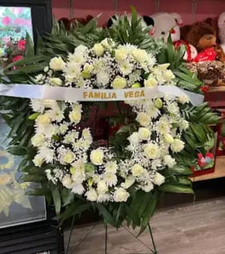 White Sympathy Wreath White Sympathy Wreath - Regular size all white sympathy wreath Mix flowers Roses, carnations, lilies, and daisies with filler green Metal stand is included*