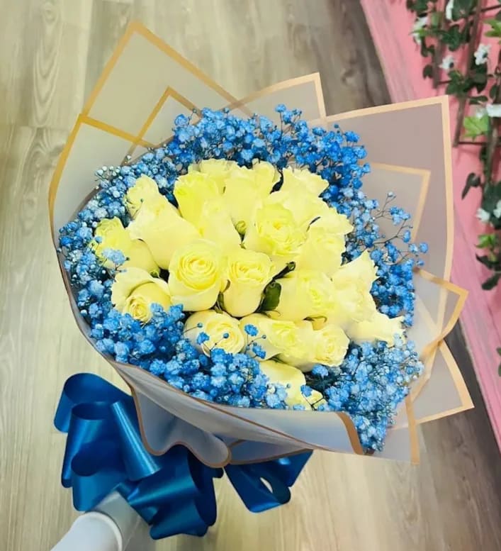 2 Dozen White Rose Bouquet 2 Dozen White Rose Bouquet - 2 Dozen white roses bouquet wrapped in paper Baby blue baby breath surrounding roses