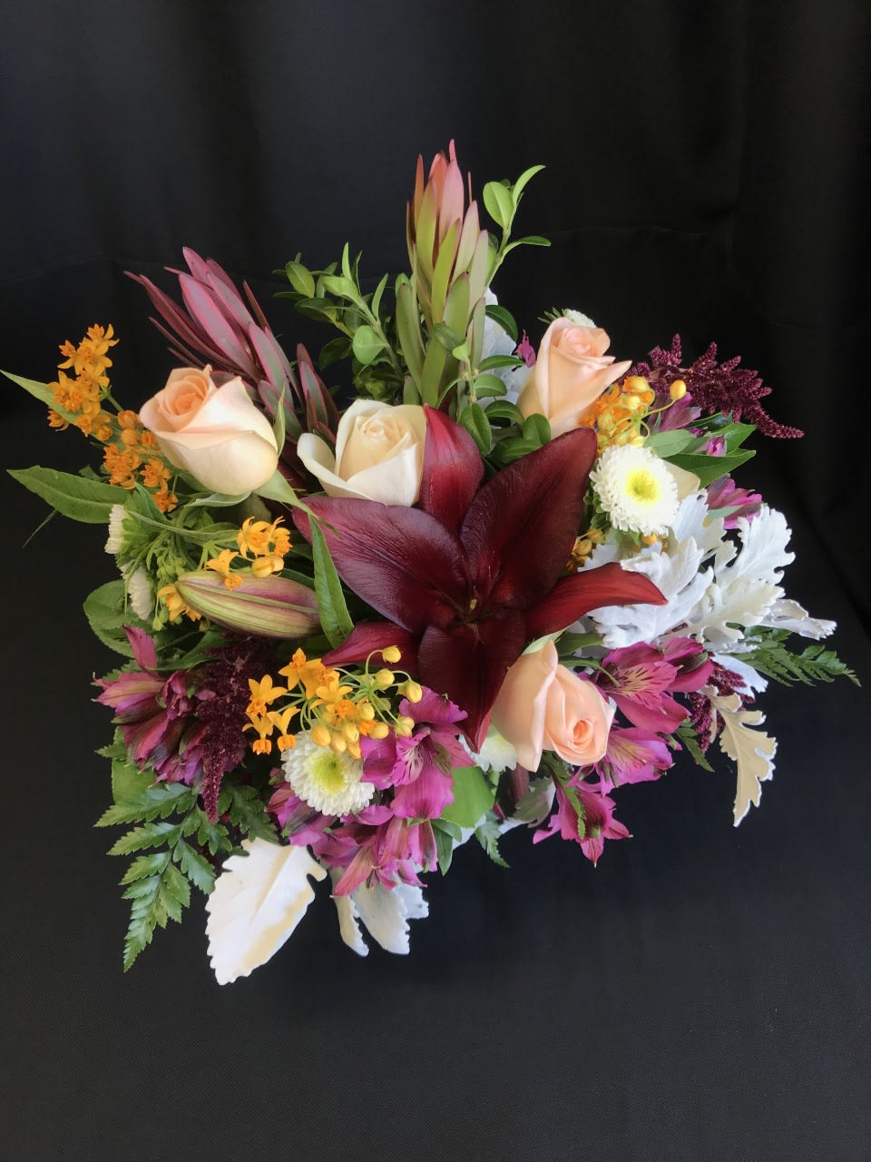 Medium High Contrast Rose Bouquet - A gorgeous mixed arrangement with contrasting colors. Color and flower varieties are designer's choice with a touch of each season as we watch the changes all around.  Will include a few roses.