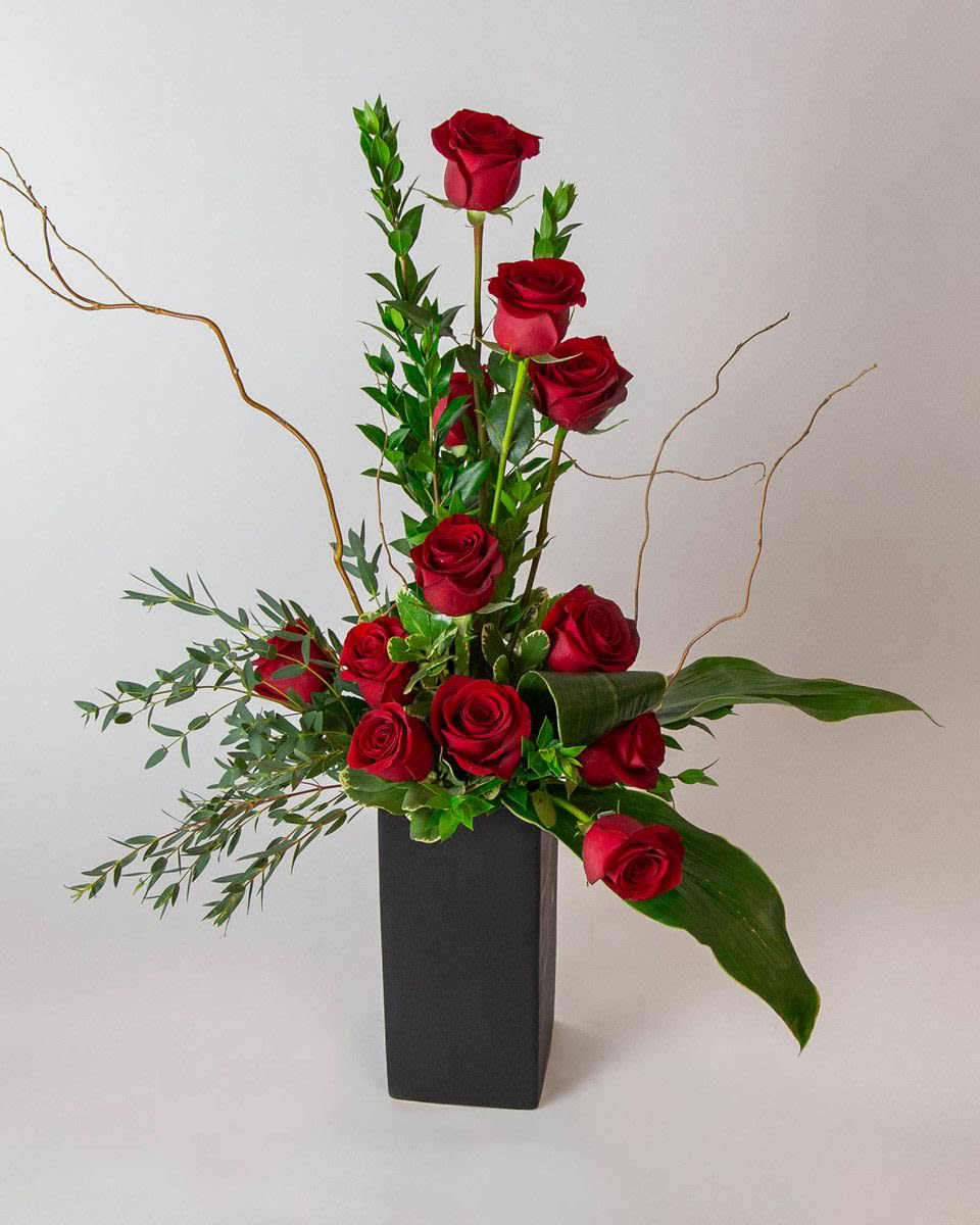 Rose Amore!! Rose Amore!! - We put a twist on the classic dozen roses to create this modern ascending spiral rose design! The Rose Amore oozes elegance and romance. The tower of 12 roses dances with twigs of curly willow and textural greenery in a contemporary matte black vase.