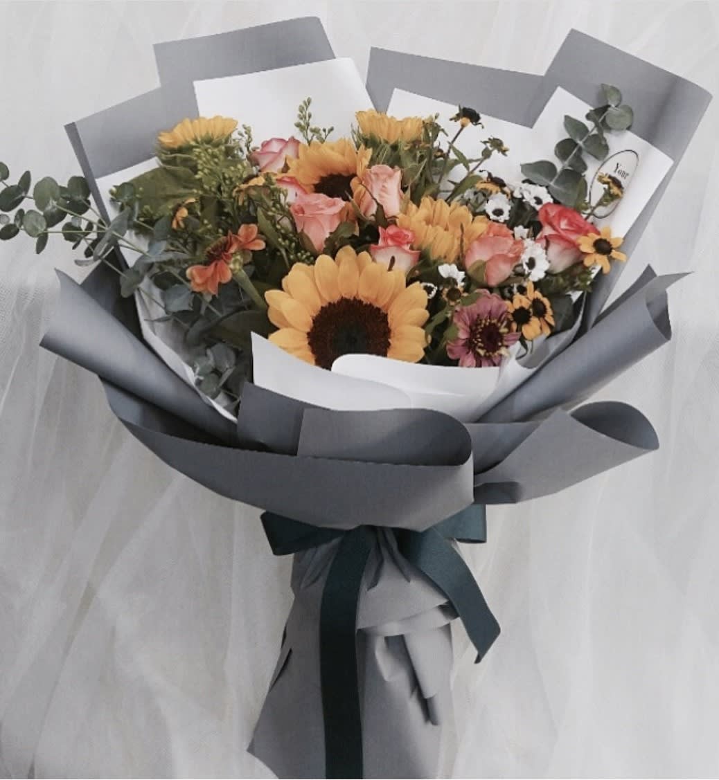 Charleston Mix Bouquet Charleston Mix Bouquet - This lovely handthight bouquet has a mix of flowers, fillers and greenery that create the beautful texture wrapped in a beutiful tissue paper to create a classic look.