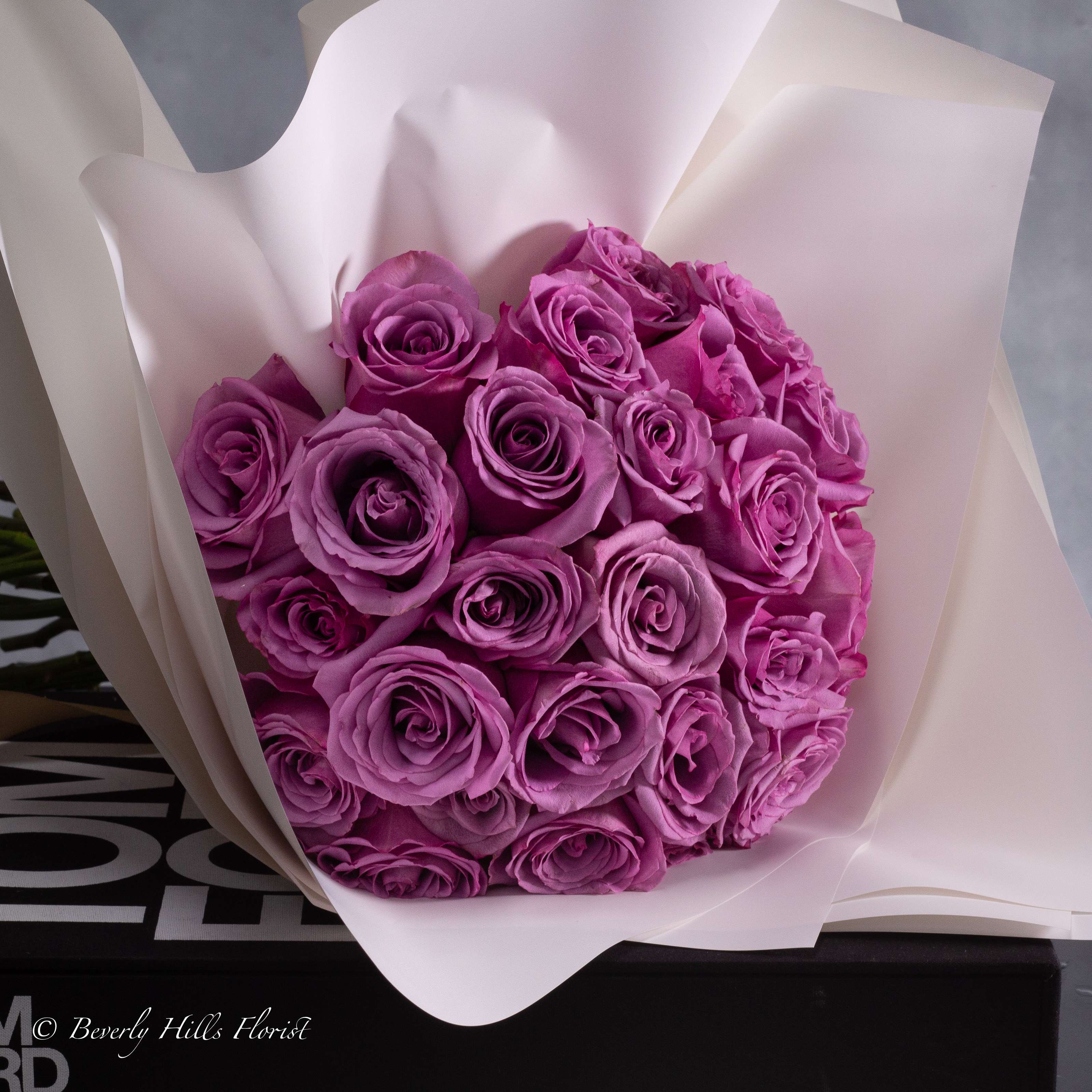 SERENITY IN BLOOM: LAVENDER ROSE BOUQUET - Pasadena Florist - With our efficient same-day delivery service, residents of Beverly Hills and nearby cities such as Los Angeles, Santa Monica, Culver City, West Hollywood, Burbank, Glendale, Pasadena, Malibu, Long Beach, and Santa Clarita can enjoy the beauty of these blooms promptly. Let us bring a touch of serenity to your doorstep, ensuring your special moments are adorned with the timeless charm of lavender roses.  Embrace tranquility with our Lavender Serenity Rose Hand Bouquet, a stunning arrangement of delicate lavender roses carefully curated to convey elegance and grace.