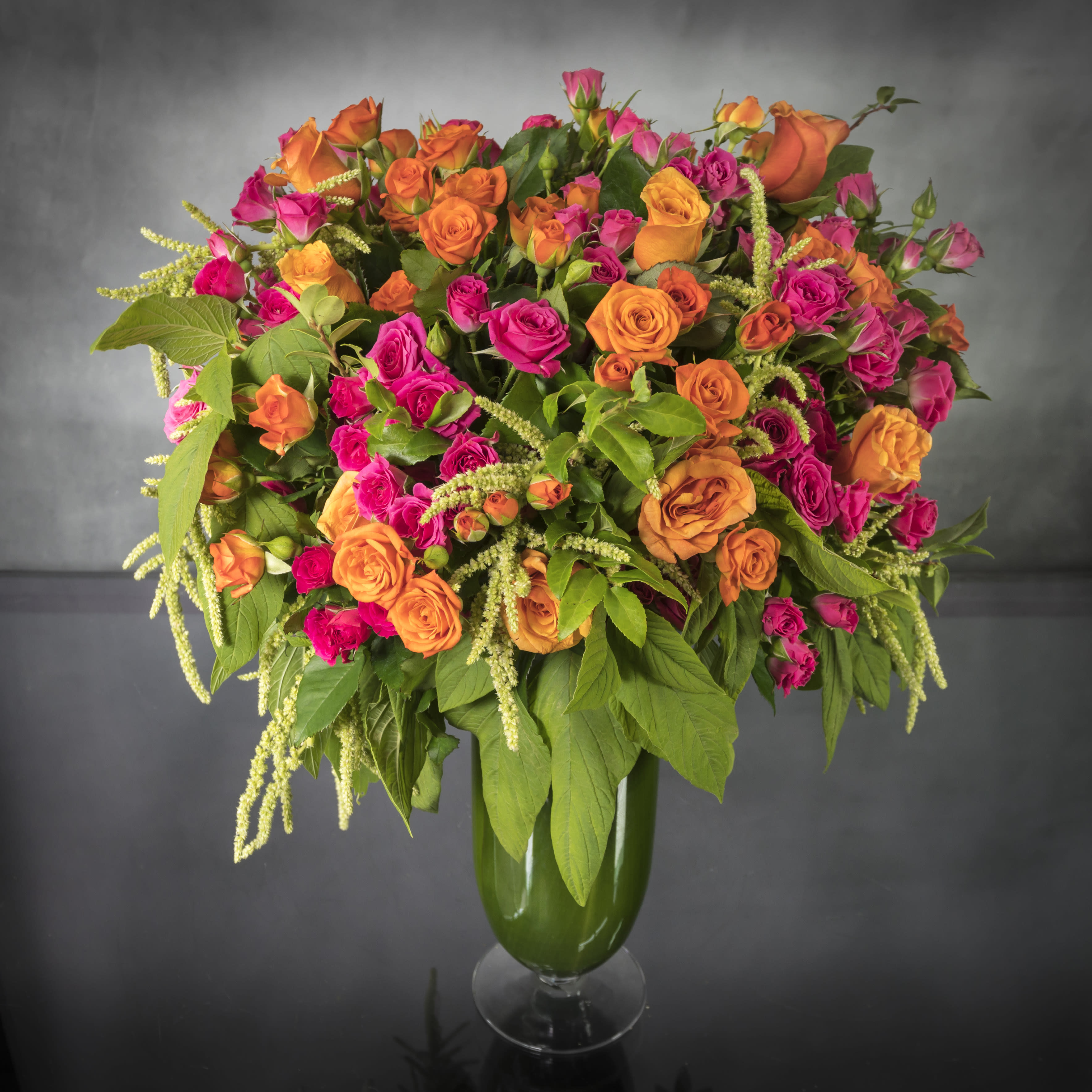 Rainbow Sherbet - Pasadena Florist - A vibrant mix of gorgeous orange and hot pink Roses in a tall glass vase. Fill their day with color with this lovely arrangement! 