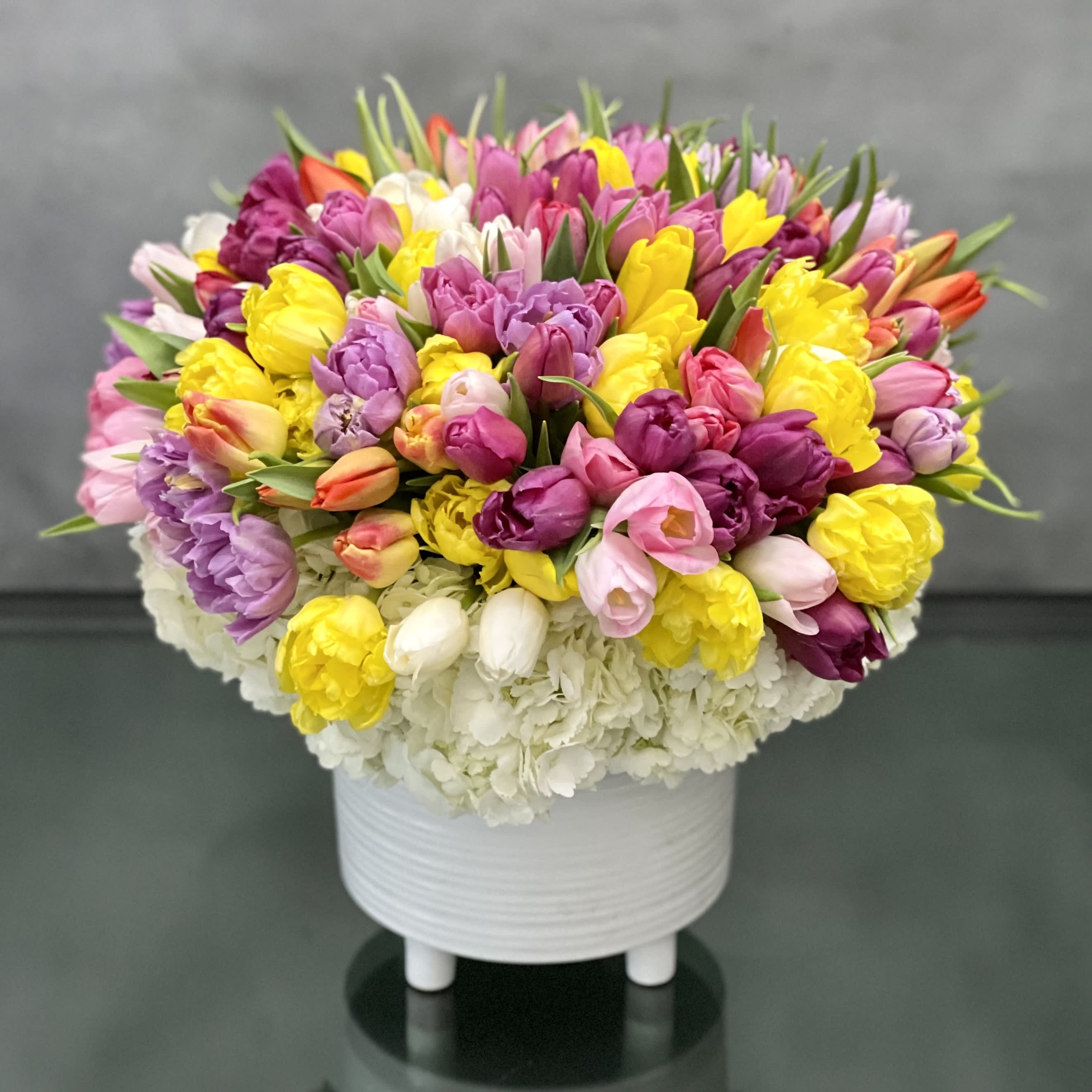 A Place in the Sun - Pasadena Florist - Bring all the excitement of spring to someone you care about with our gathering of tulips &amp; Hydrangeas. A delightful blend of pinks, purples and yellows come together in this elegant bouquet, which is sure to be the standout of the season.  Standard: 100 Mixed Spring Tulips   Deluxe: 150 Mixed Spring Tulips  