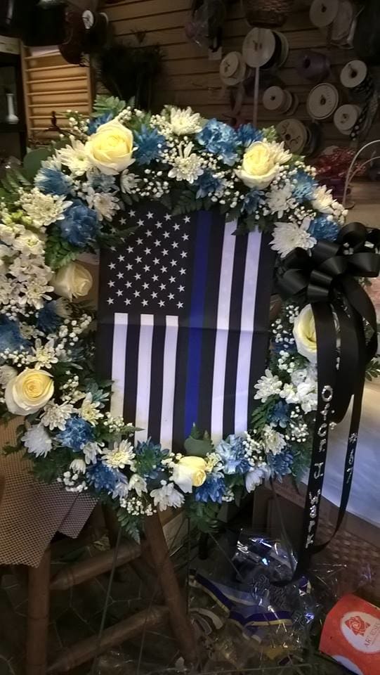 Distinction of Honor Distinction of Honor - An elegant ring of serene flowers create a strong and loving tribute to a life distinguished by patriotism, honor and dedication.