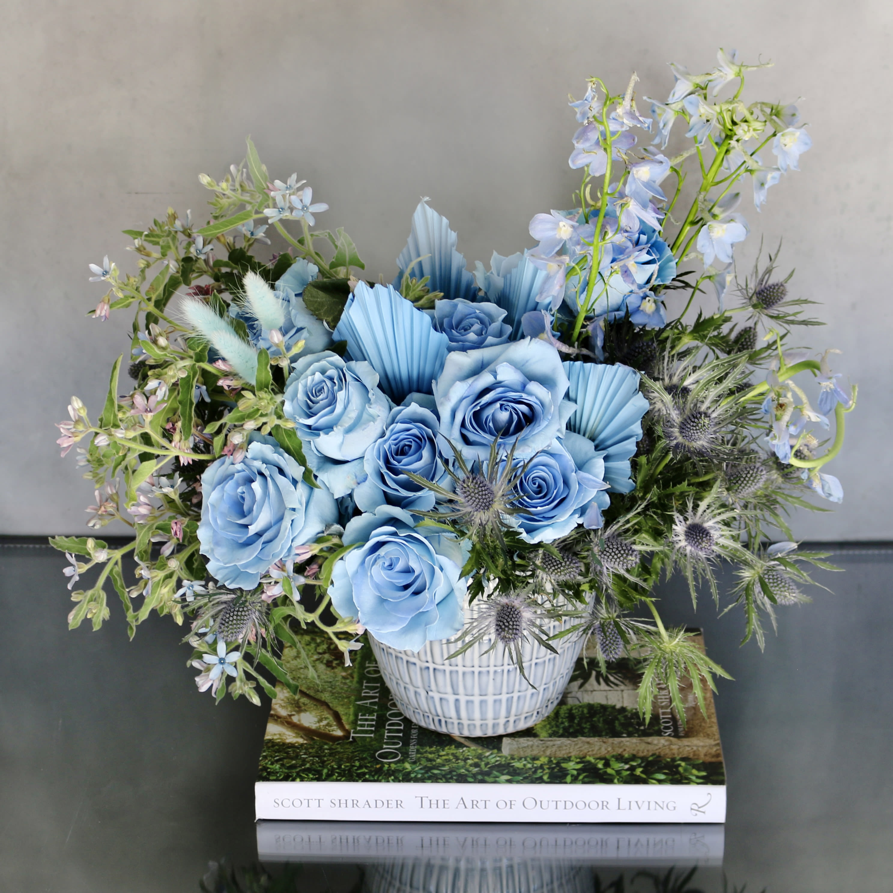 Mr. Blue Sky - Pasadena Florist - Adding to our collection with a twist of something new is our &quot;Mr. Blue Sky&quot; ! A beautiful arrangement made with baby blue Roses, Thistles and various blue spring florals. All arranged within a blue ceramic vase. Perfect for a welcome baby, birthday or just because !   Measurement:  Vase: 6x6 Arrangement: 18x18