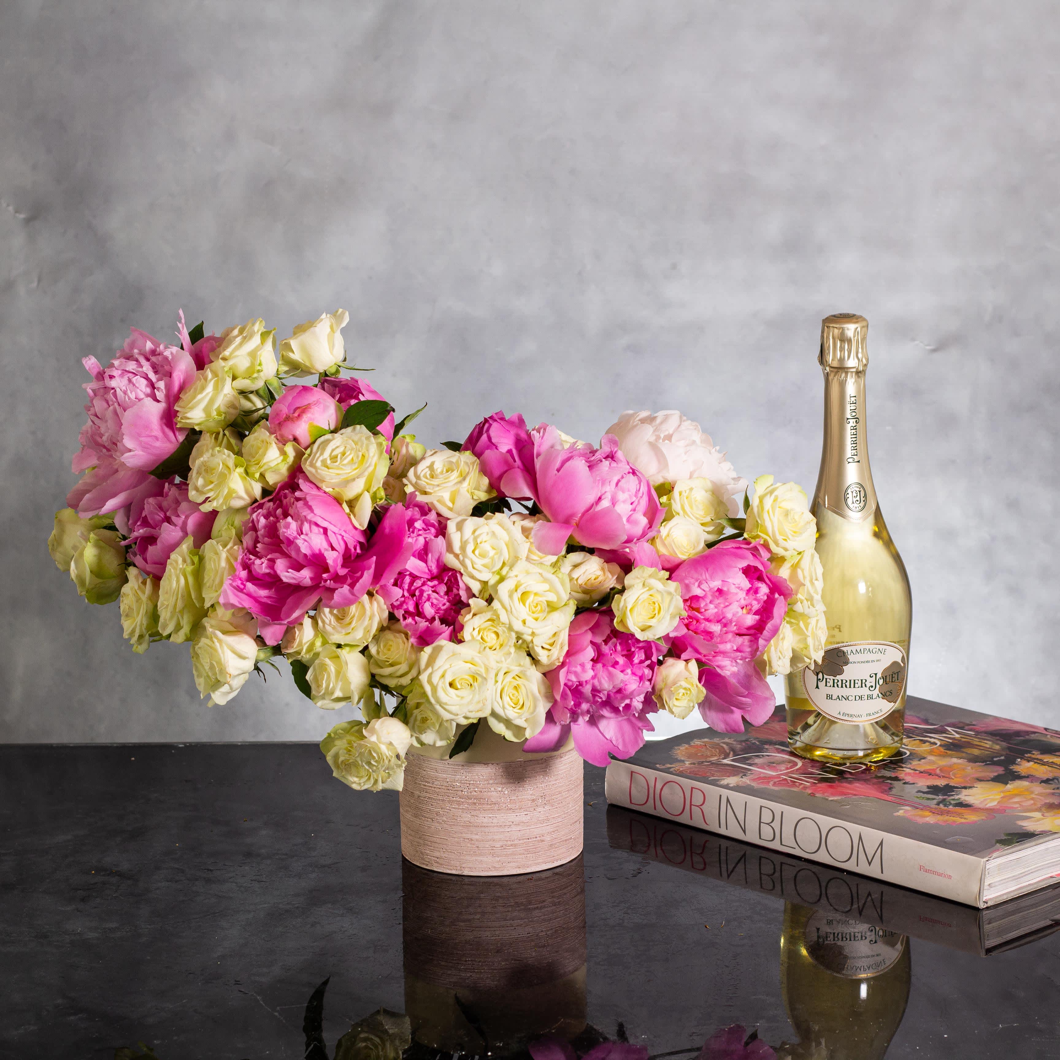Pink Petal Perfume - Pasadena Florist - Immerse yourself in a fragrant symphony with our enchanting floral creation, &quot;Pink Petal Perfume.&quot; Delicate pink peonies elegantly spray from a modern ceramic vase, creating a striking visual and aromatic delight. Standing at a corrected height of approximately 18 inches in length and 17 inches tall, this arrangement exudes charm and freshness. Let the graceful allure of pink peonies captivate your senses and add a touch of natural beauty to your space.