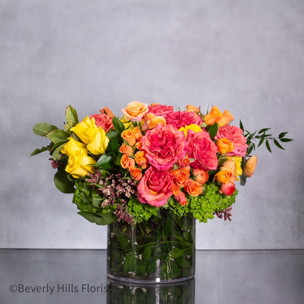 colorful sophistication - Pasadena Florist - Introducing our &quot;Colorful Sophistication&quot; floral arrangement – a captivating masterpiece designed to impress. Measuring 28 inches round, this arrangement is generously filled with a stunning array of mixed roses, ranunculus, and other locally and imported flowers, creating a compact yet lush display bursting with vibrant colors and textures.  Each bloom is carefully selected for its freshness and beauty, ensuring that every petal is at its prime. Whether you're celebrating a milestone in Beverly Hills or hosting a chic event in the Hollywood Hills, this arrangement exudes elegance and charm.  With its full-bodied design and vibrant hues, &quot;Colorful Sophistication&quot; is the perfect centerpiece for any occasion, from lavish parties to intimate gatherings. Let us elevate your event with this stunning floral creation, meticulously crafted to add a touch of glamour and style to your celebration.  Order now and experience the beauty of &quot;Colorful Sophistication&quot; delivered straight to your doorstep, ready to enchant and delight.