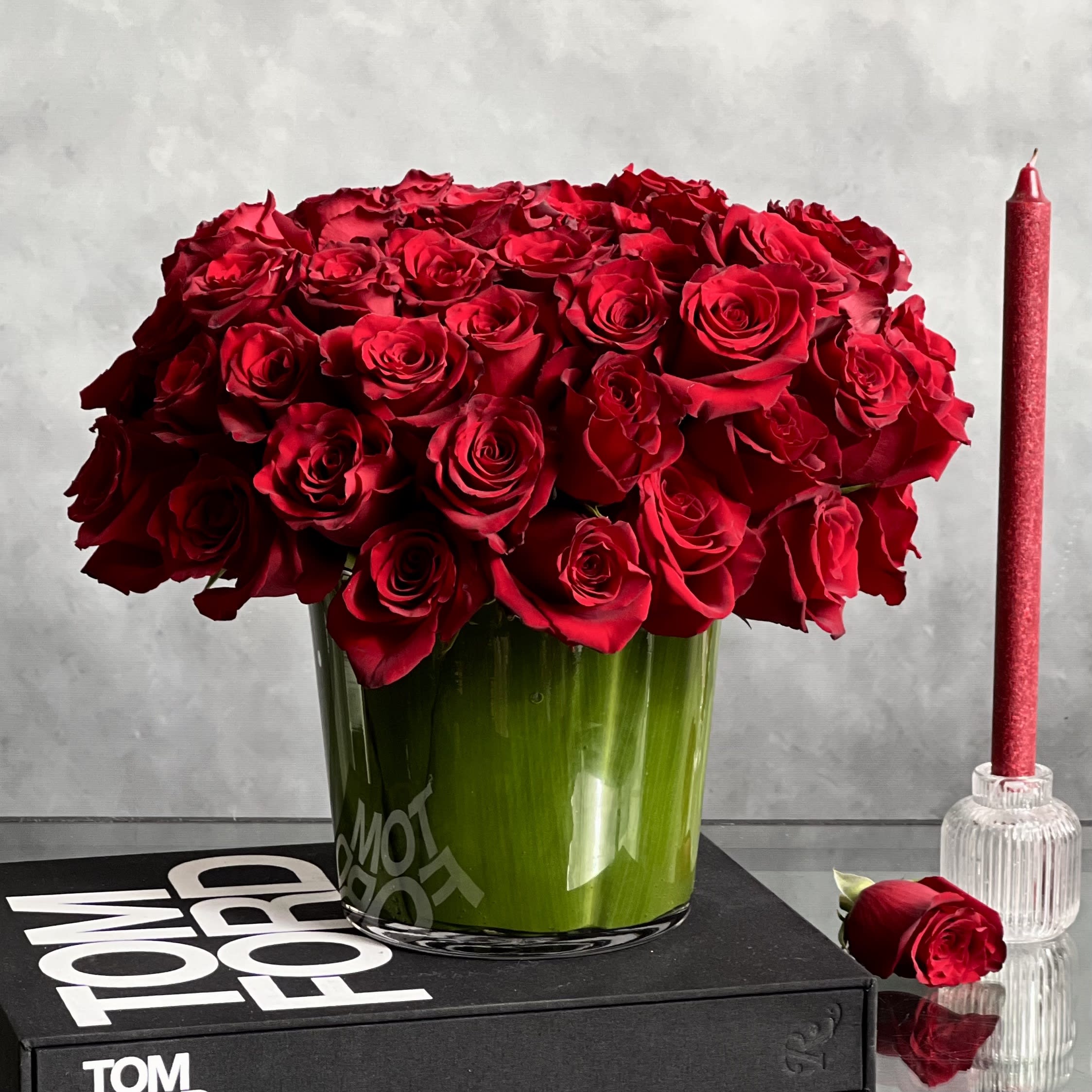 Kiss from a Rose - Pasadena Florist - One of the most renowned and heavily symbolic flowers, Here, our designers have chosen a minimalist styled design to showcase the splendor of up to 75 luscious roses. The arrangement rests in a 7&quot; Glass vase lined with Leaves.  Measurement 14&quot; Tall and 15&quot; Wide