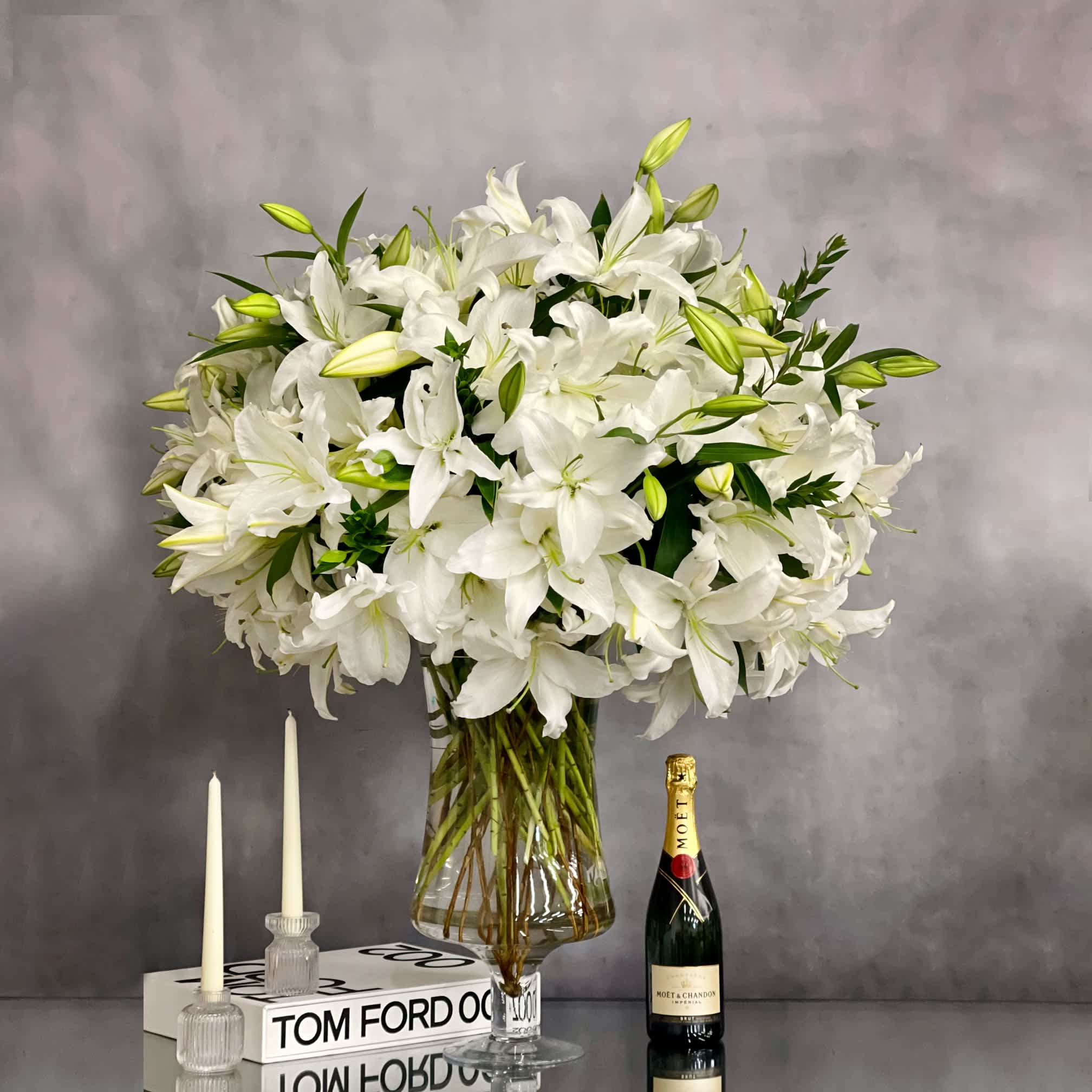 Lily Galore - Pasadena Florist  - An arrangement that is made with 50 stems of Casablanca Lillies. A glorious and simplistic chic arrangement which is sure to make a statement. All arranged within a tall standing glass vase. 