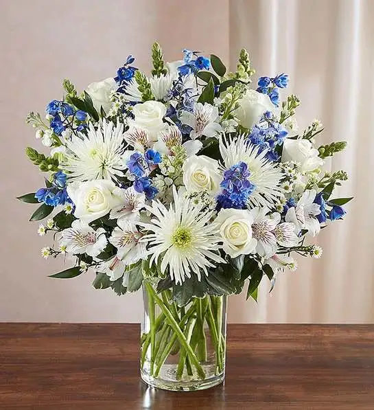 Sincerest Sorrow Blue & White Sincerest Sorrow Blue & White - A sincerity of sentiment means so much to those grieving. Our bountiful, heavenly blue and white bouquet features a soothing mix of blue delphinium, alstroemeria, and white roses, hand-designed inside a classic clear glass vase. When sent to a service or to the home of family or friends, it makes a genuinely heartwarming gesture.