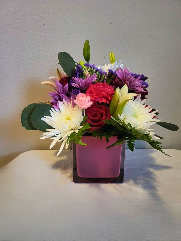Sending Smiles Cube Special - Royal - Rich in purple accents, this arrangement will bring royal smiles to the beholder.