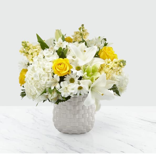 Comfort and Grace Bouquet Comfort and Grace Bouquet - Our Comfort and Grace is elegantly crafted by our passionate and dedicated local florists to compliment your heartfelt sympathies. A collection of roses, stock, hydrangea and lilies is a timeless gift to share during times of sensitivity. While the lilies initially come in bud form, they beautifully transform into flowers as they open. The Original Bouquet is approximately 17"H x 18"W.