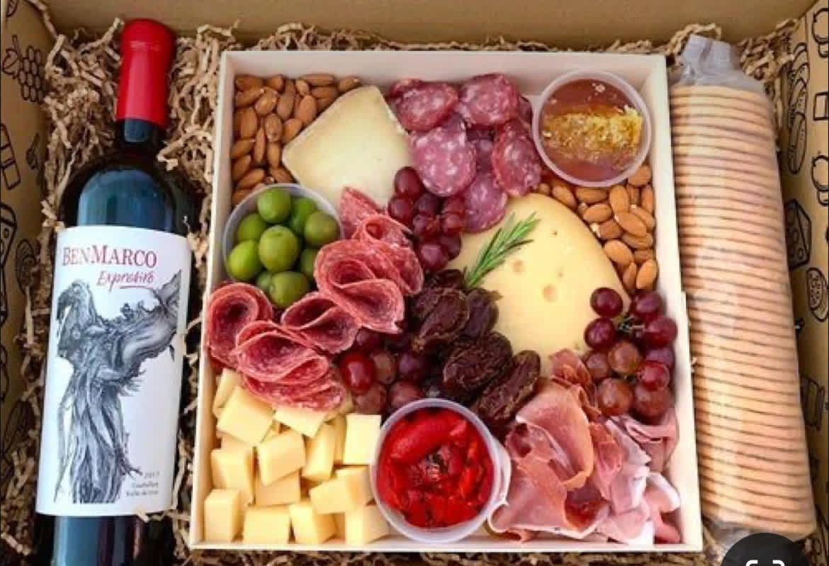 Charcuterie Board Charcuterie Board - A mix of charcuterie and cheeses, fruit, nuts and wine