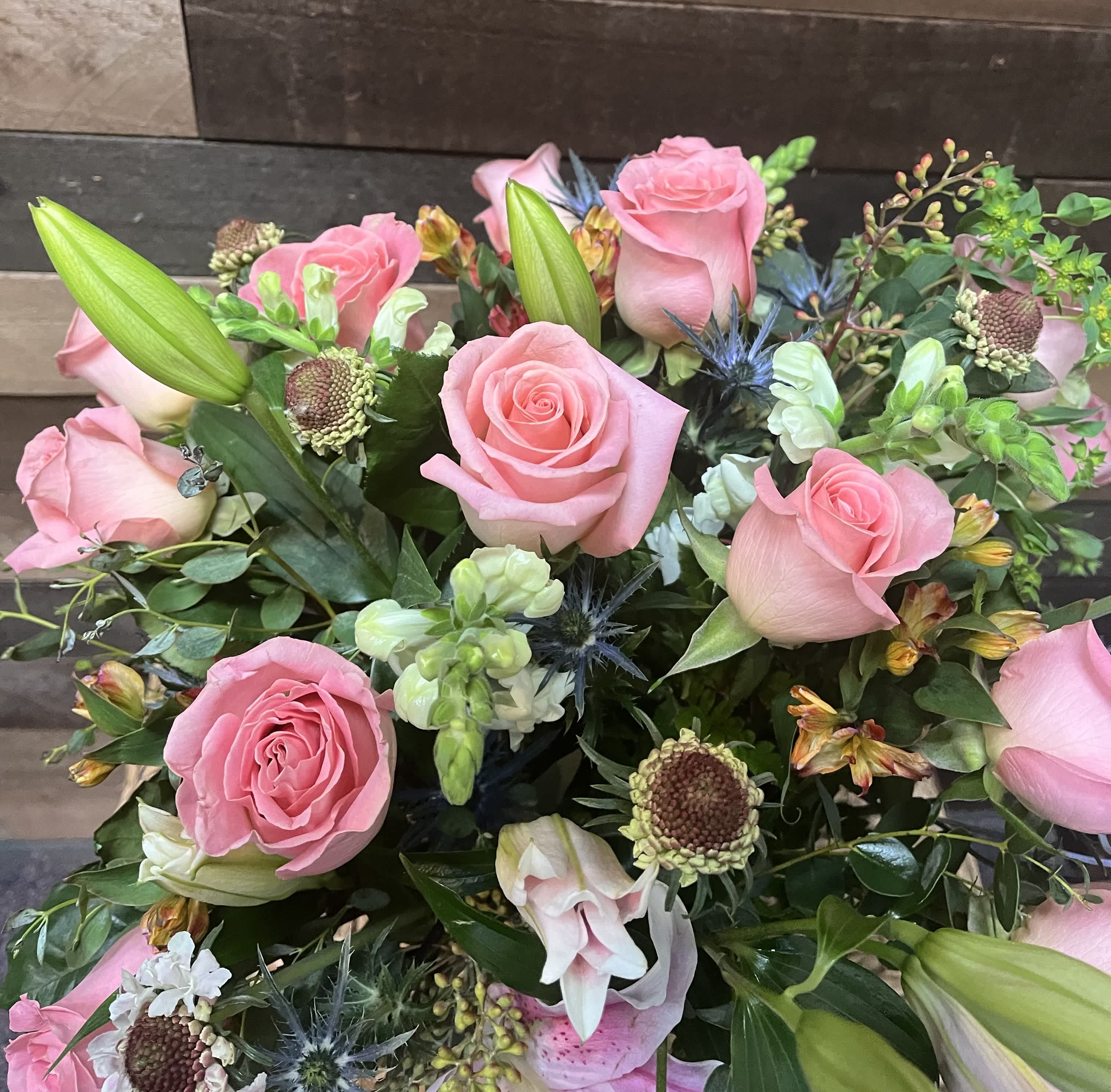 Paradise Petals Paradise Petals - A lush bouquet featuring pink roses, elegant lilies, vibrant greenery, fragrant stock, and colorful alstroemerias, perfect for bringing a touch of paradise to any celebration or space.