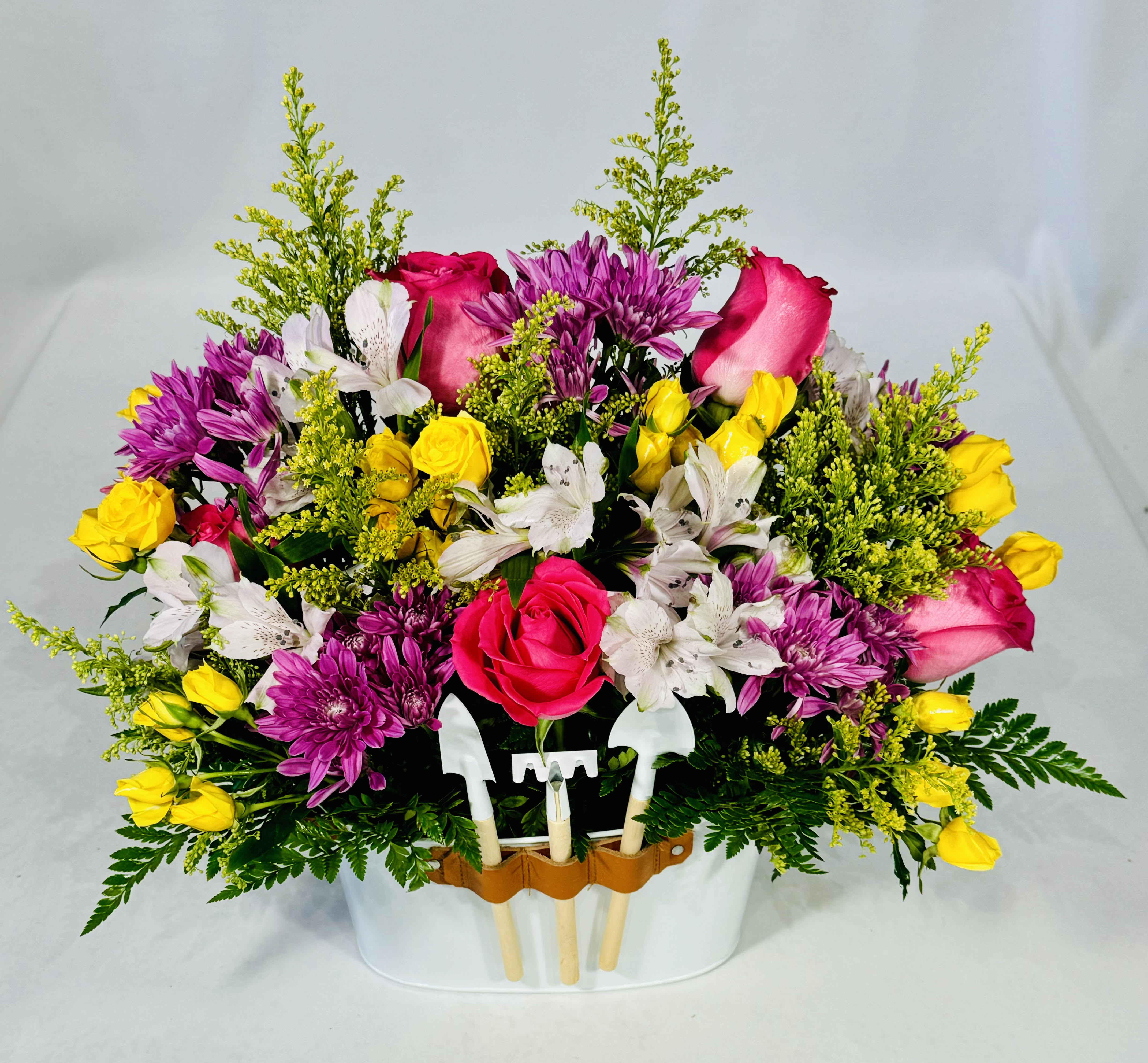 Summer Day Flower Garden - Summer Day Flower Garden comes adorned with Hot Pink Roses, Purple Daisies, White Alstroemeria, Yellow Sweetheart Roses and Solidago. All complete with a 3 pc. coordinating mini tool set and reusable pail. Wonderful floral arrangement sure to brighten someone's day. Perfect for any occasion. 12&quot; H