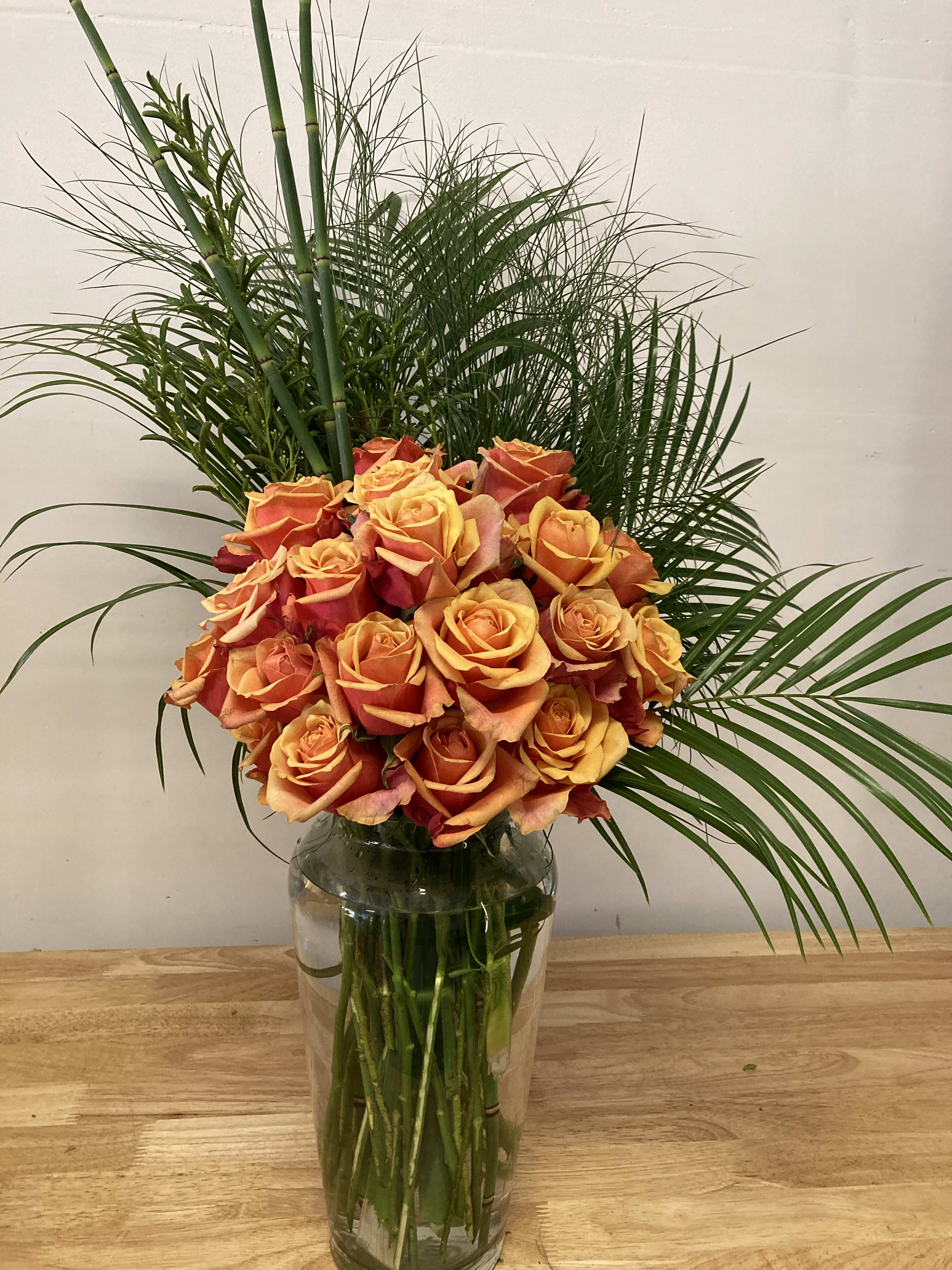 Wild Rose Wild Rose - Roses are a Symbol of Balance. They express Promise, new beginnings and hope. Wild Rose is a grand vase centerpiece consisting of Two dozen Cherry Brandy Roses with Palms and Papyrus Grass. Truly make a statement with this signature floral for any and all special occasions. All of our roses are locally grown and delivered fresh daily. Servicing Santa Maria, Arroyo Grande, Oceano and the greater Santa Barbara County. Also servicing San Luis Obispo County.