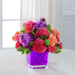 Color Burst - Dazzling and delightful, this bold and colorful flower bouquet is set to impress with it's high impact look and graceful styling. Hot pink carnations, orange carnations, purple gilly flower, hot pink mini carnations, green button poms, and fresh greens.