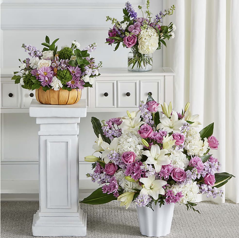 Lavender Reflections Bundle - Featuring heartwarming lavenders and whites, the traditional arrangements of this sympathy set are meant for celebrating the life of a loved one at a visitation, funeral, church service, cremation, or cemetery service – or as a delivery to the family's home.