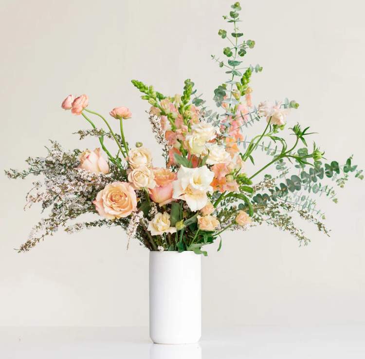Natural & Elegant Natural & Elegant - Make a statement! Our tall flower arrangement is perfect for styling an entryway table. The tall modern vase gives added height to this wild floral design. Select your preferred flower color palette, or choose "Seasonal" and let our florists surprise you with a selection of blooms that are unique to this time of year.